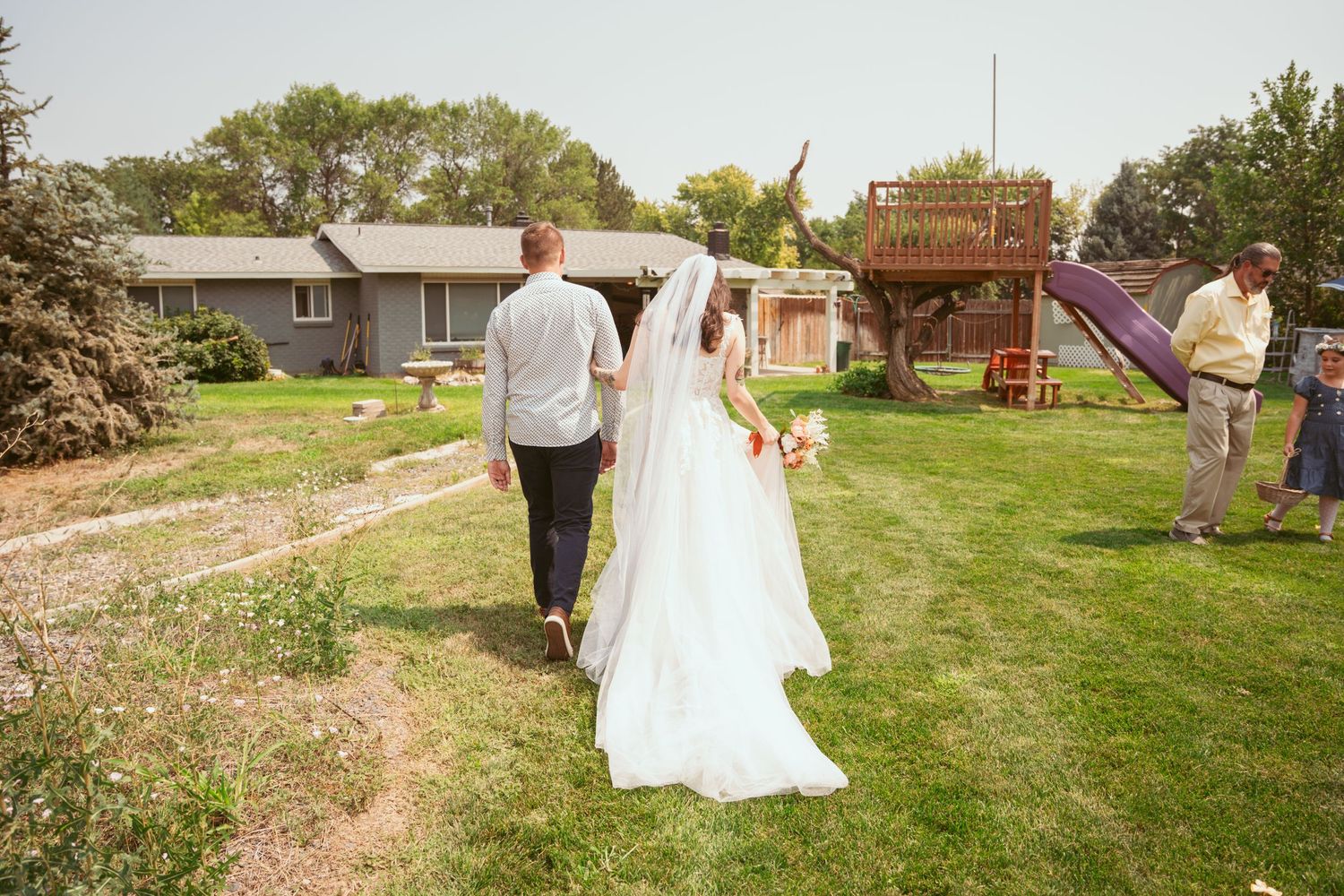 Wedding celebration in a scenic outdoor garden setting with decorative elements.