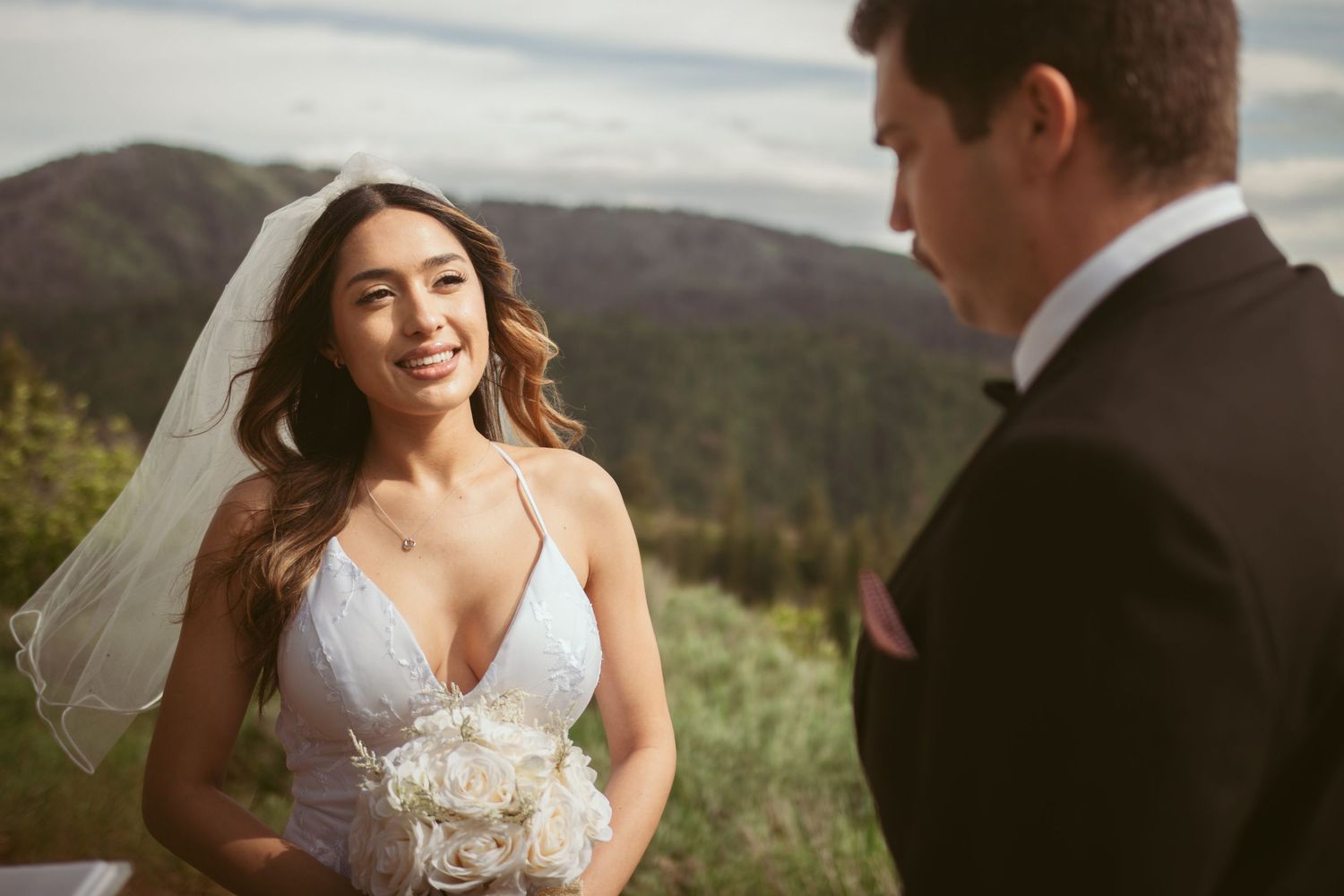An intimate mountain wedding ceremony with scenic views and natural landscape in the background.