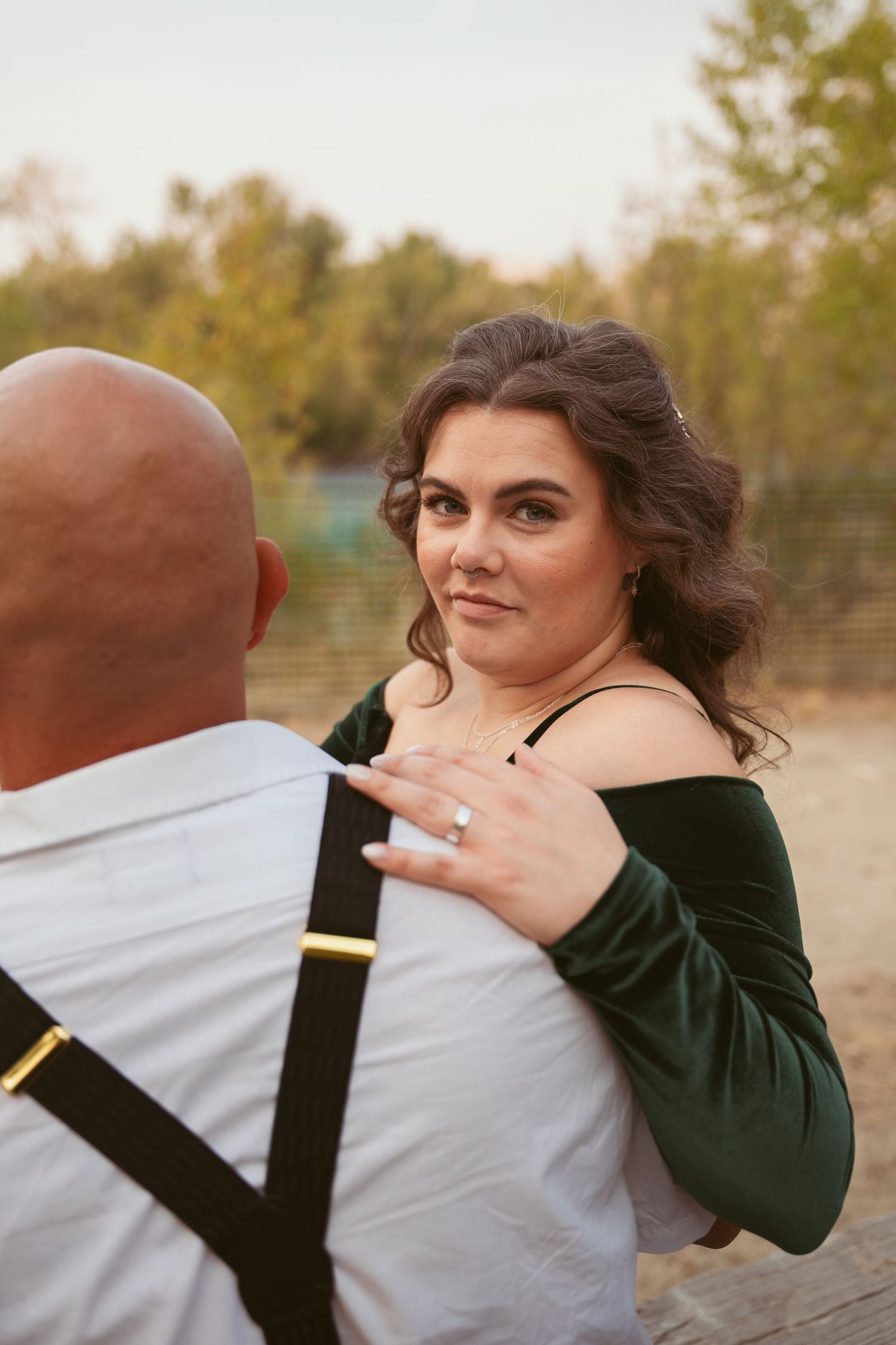 Couple in contrasting dark and light outfits sharing playful moments outdoors.