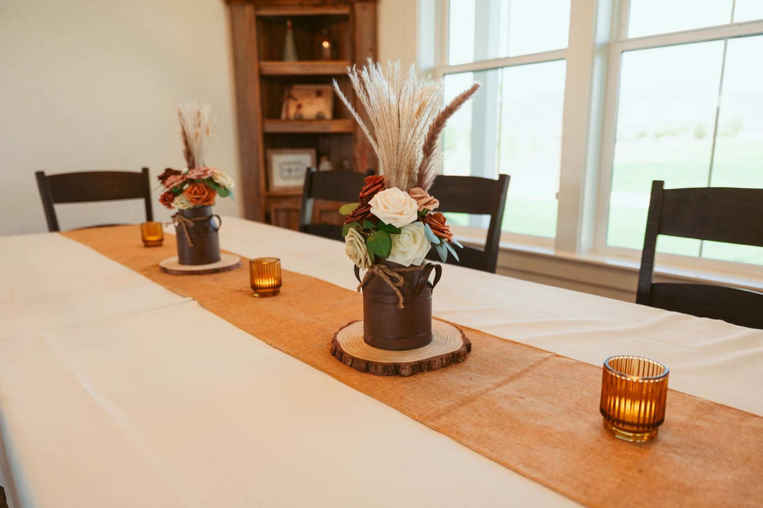 Minimalist wedding reception table setting with warm lighting and natural decor elements.