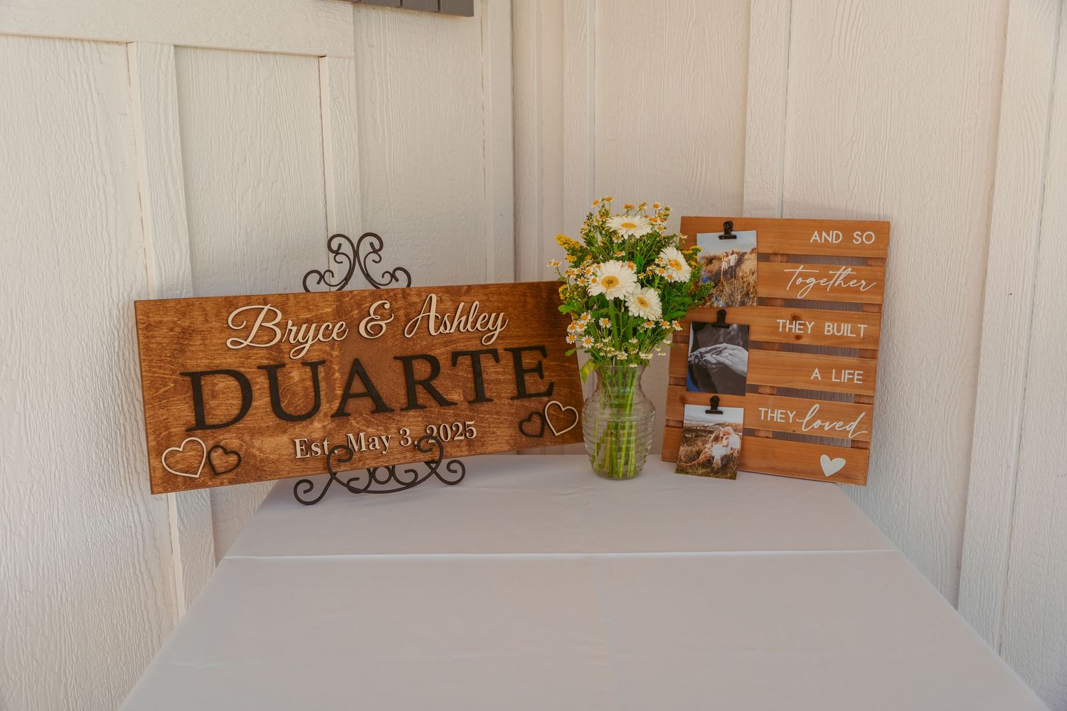 Rustic wooden signs and decor displayed against a white wall.