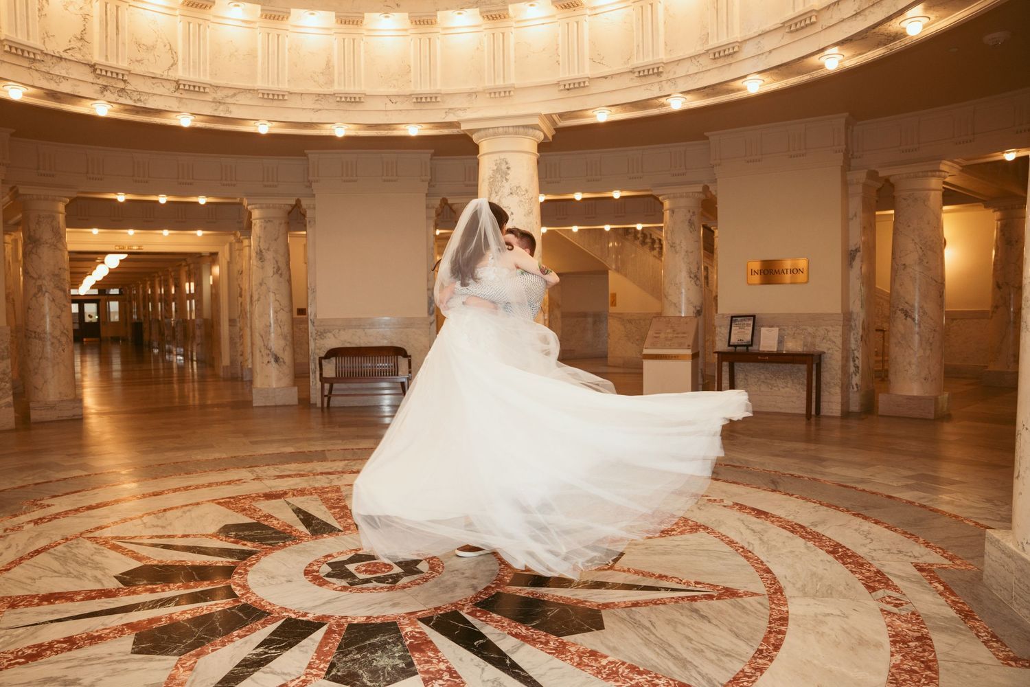 Grand ballroom interior with circular ceiling design and elegant lighting fixtures.