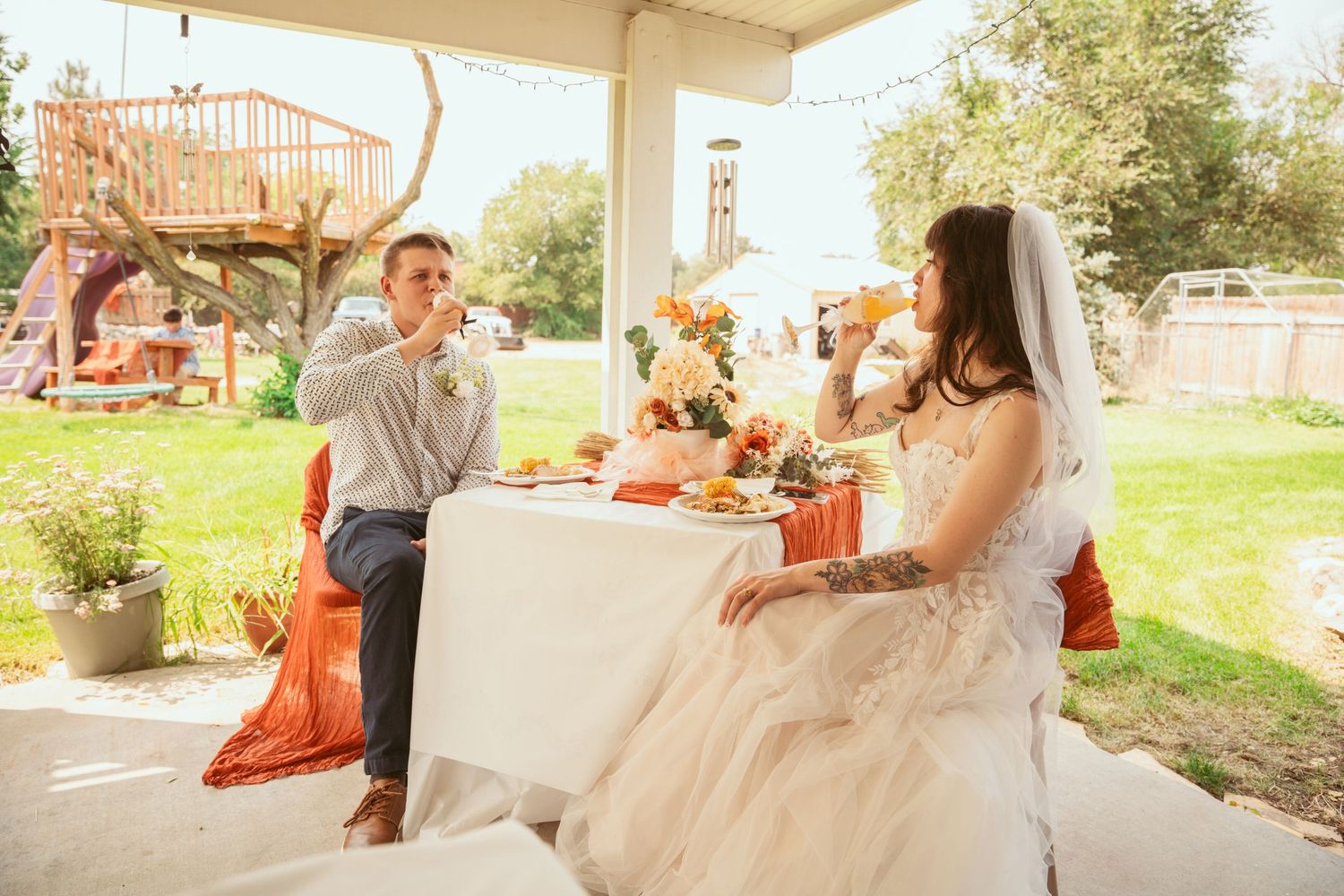 Wedding celebration on an outdoor porch with autumn decorations.