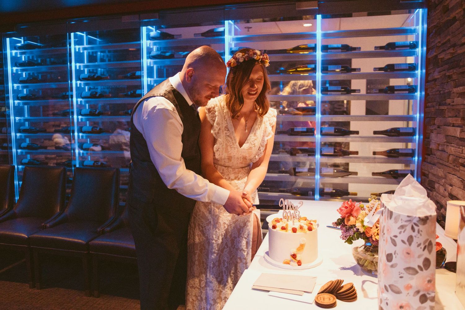 Wedding reception venue with blue ambient lighting and exposed brick walls.