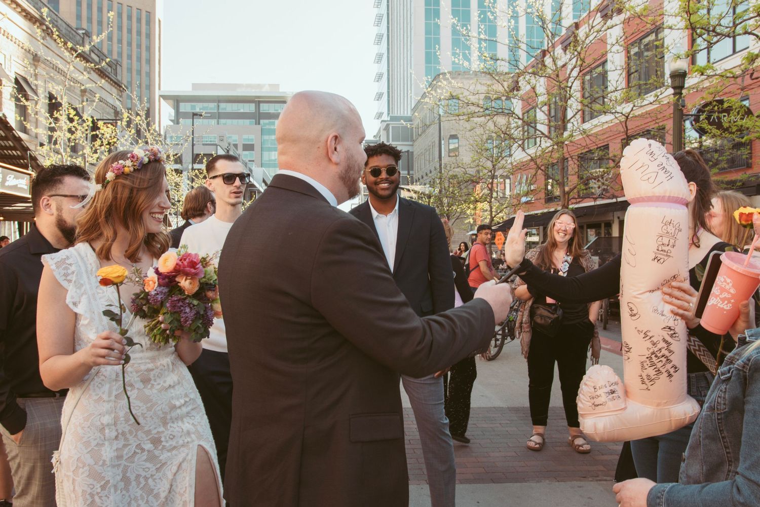 Urban wedding celebration with city buildings and skyscrapers in the background.