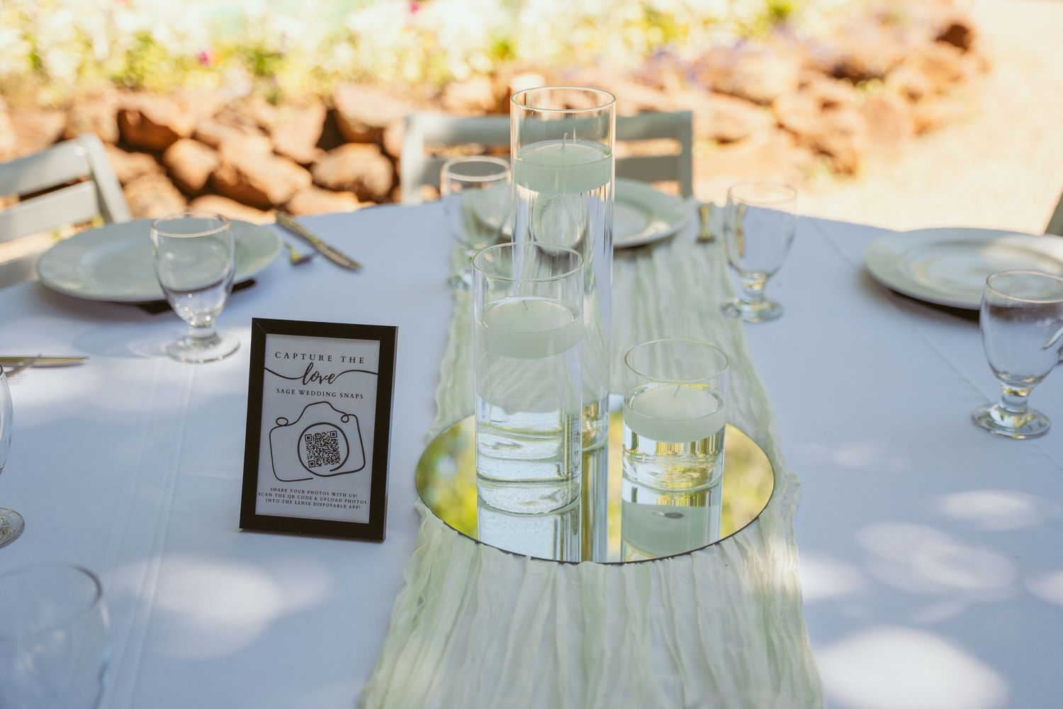 Elegant table settings with white linens and glassware arranged for a formal dining event.