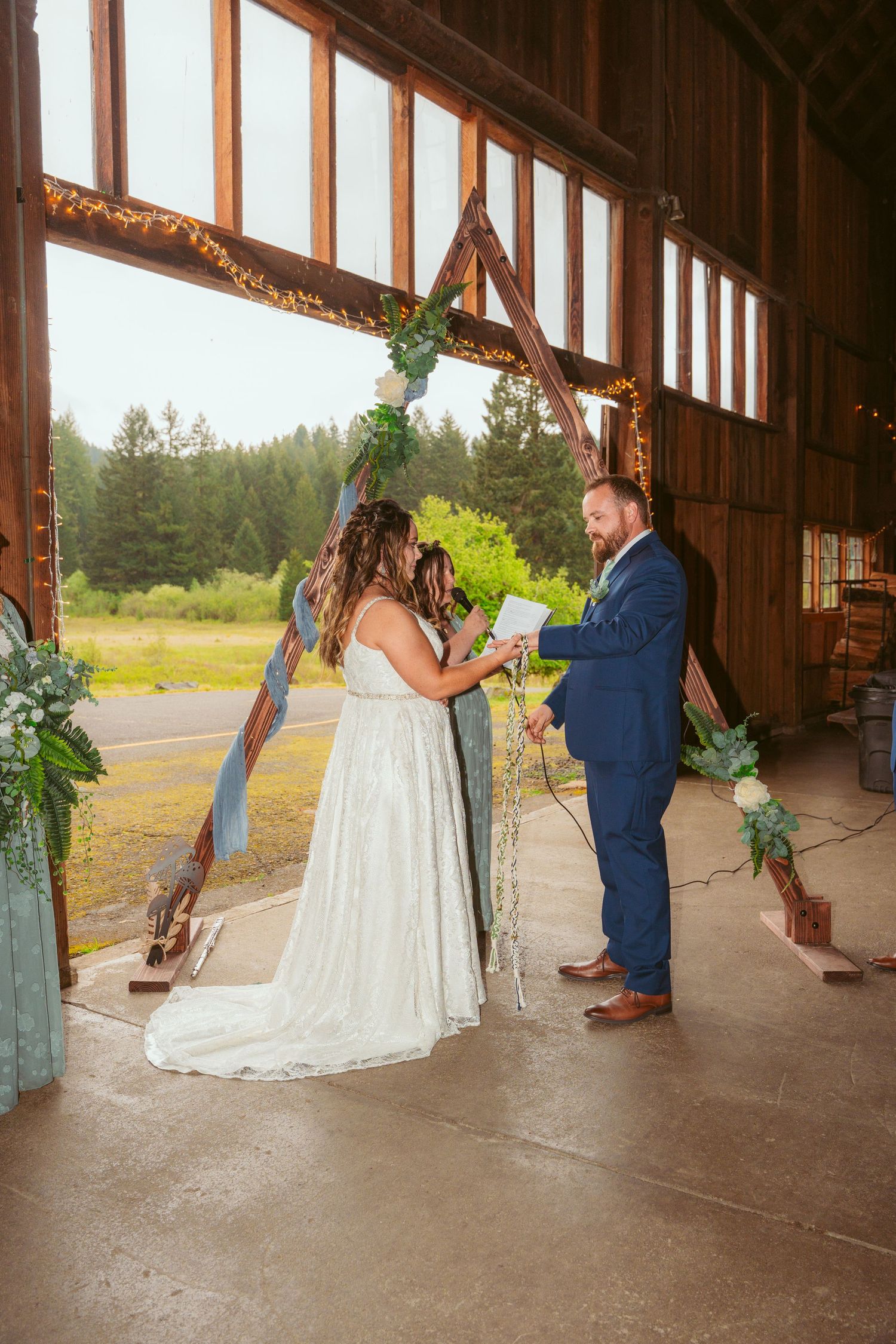 Wedding ceremony moments captured in sequence inside a rustic wooden barn.