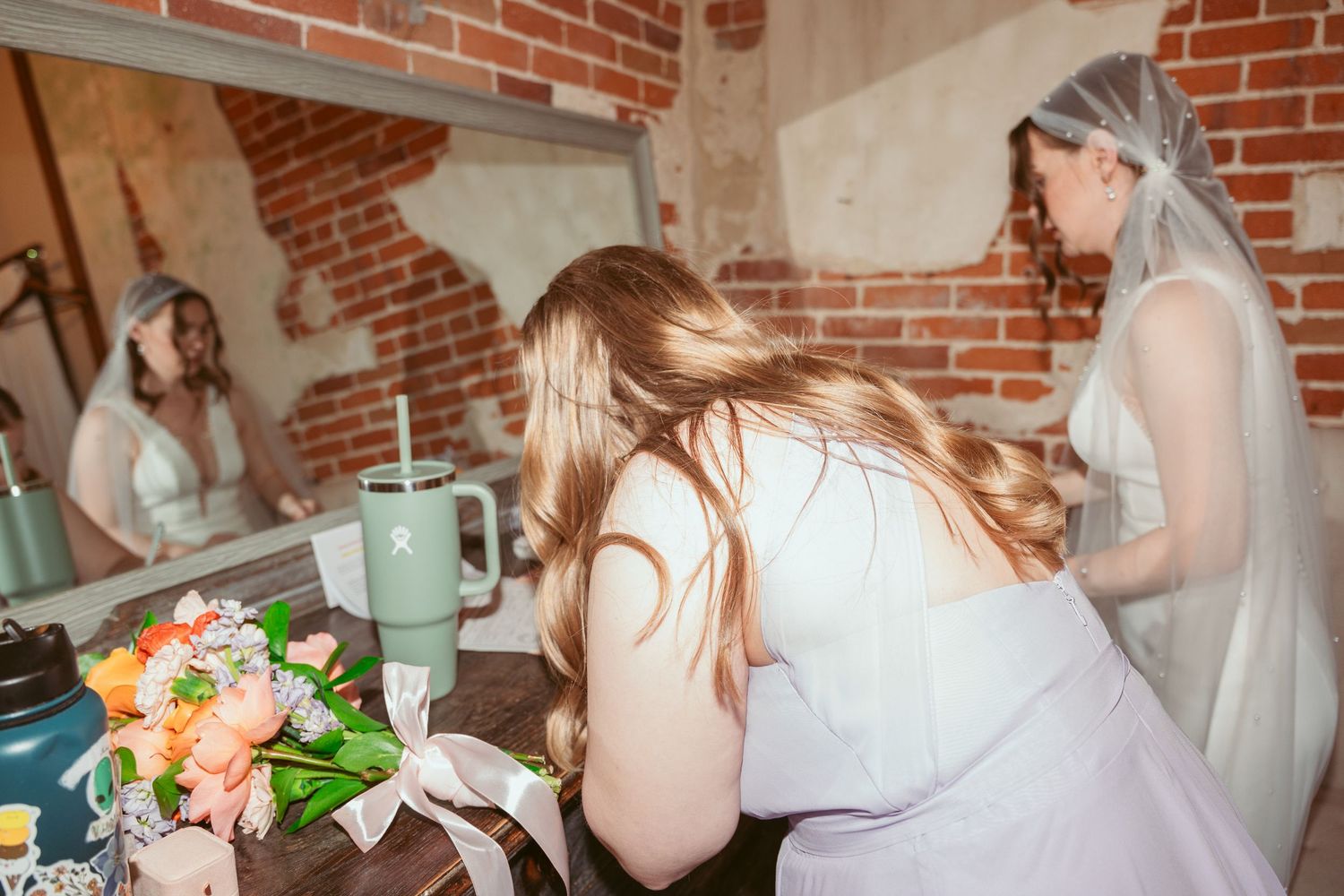 Wedding celebration candid moments captured in a rustic brick venue.