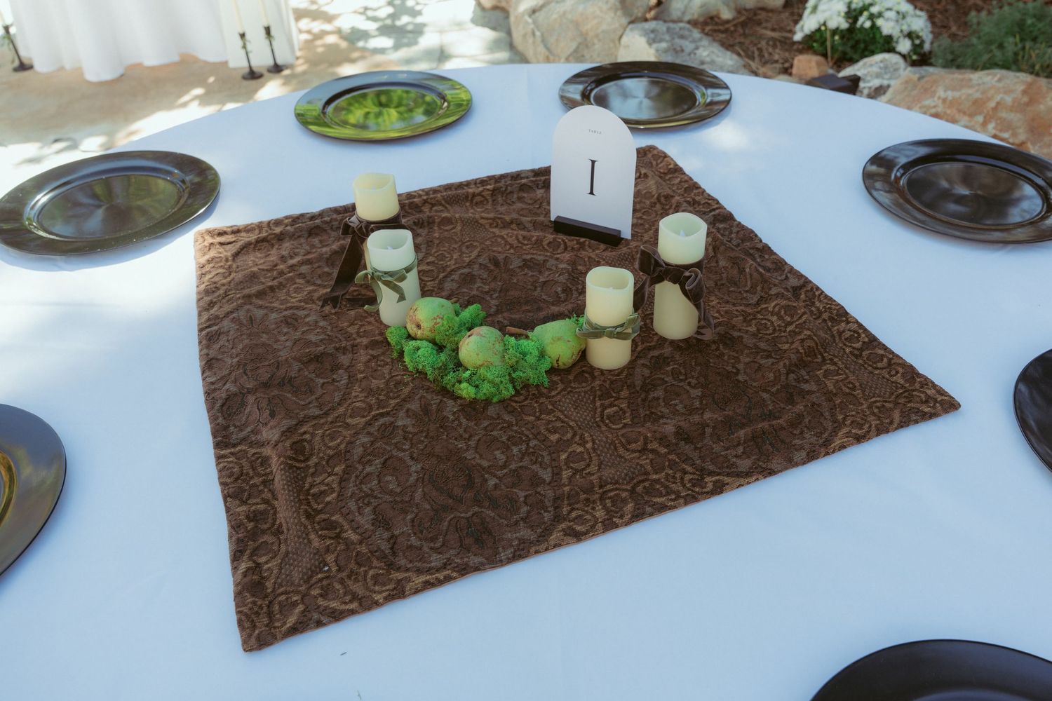 Wedding reception table with brown and white decorative elements.