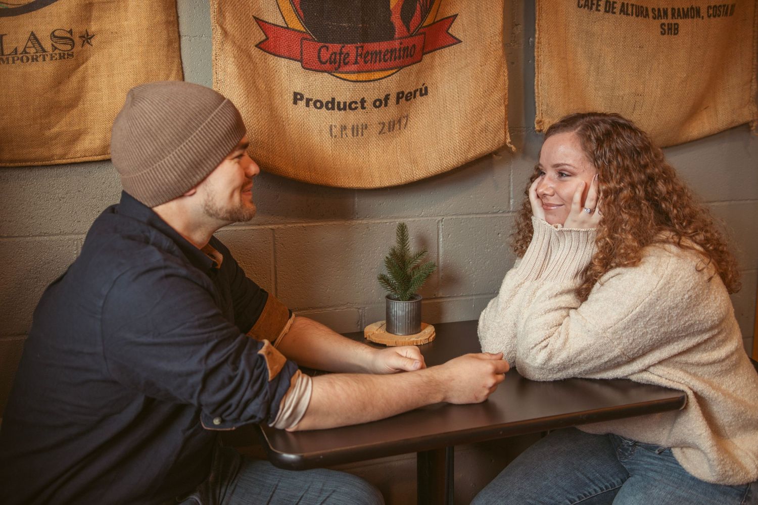 A cozy coffee shop scene with warm lighting and rustic wooden tables.
