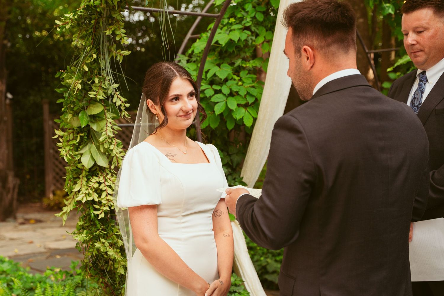 Garden wedding ceremony with natural greenery and elegant decorations.