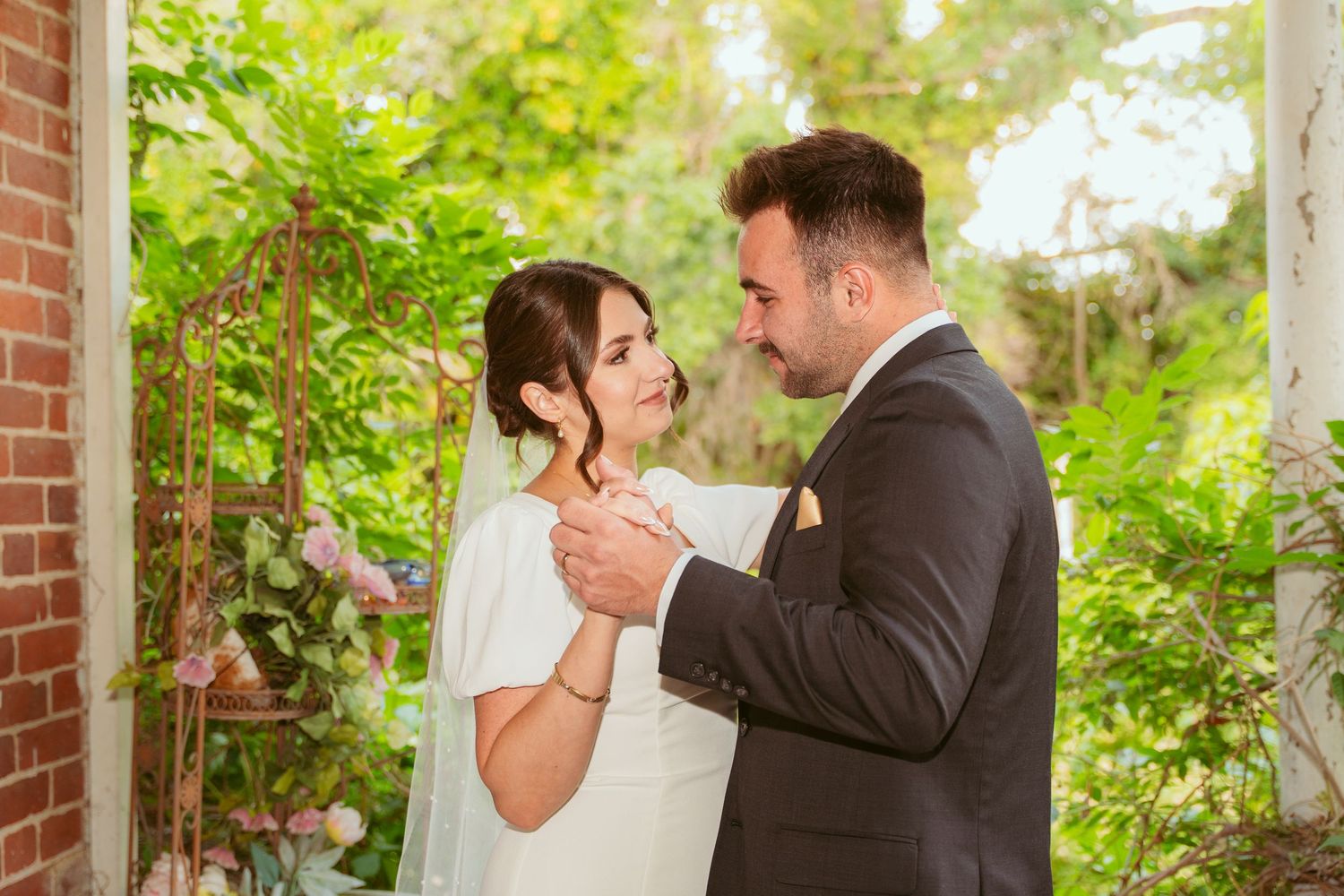 Romantic wedding sequence showing tender moments between newlyweds on a brick-walled porch.
