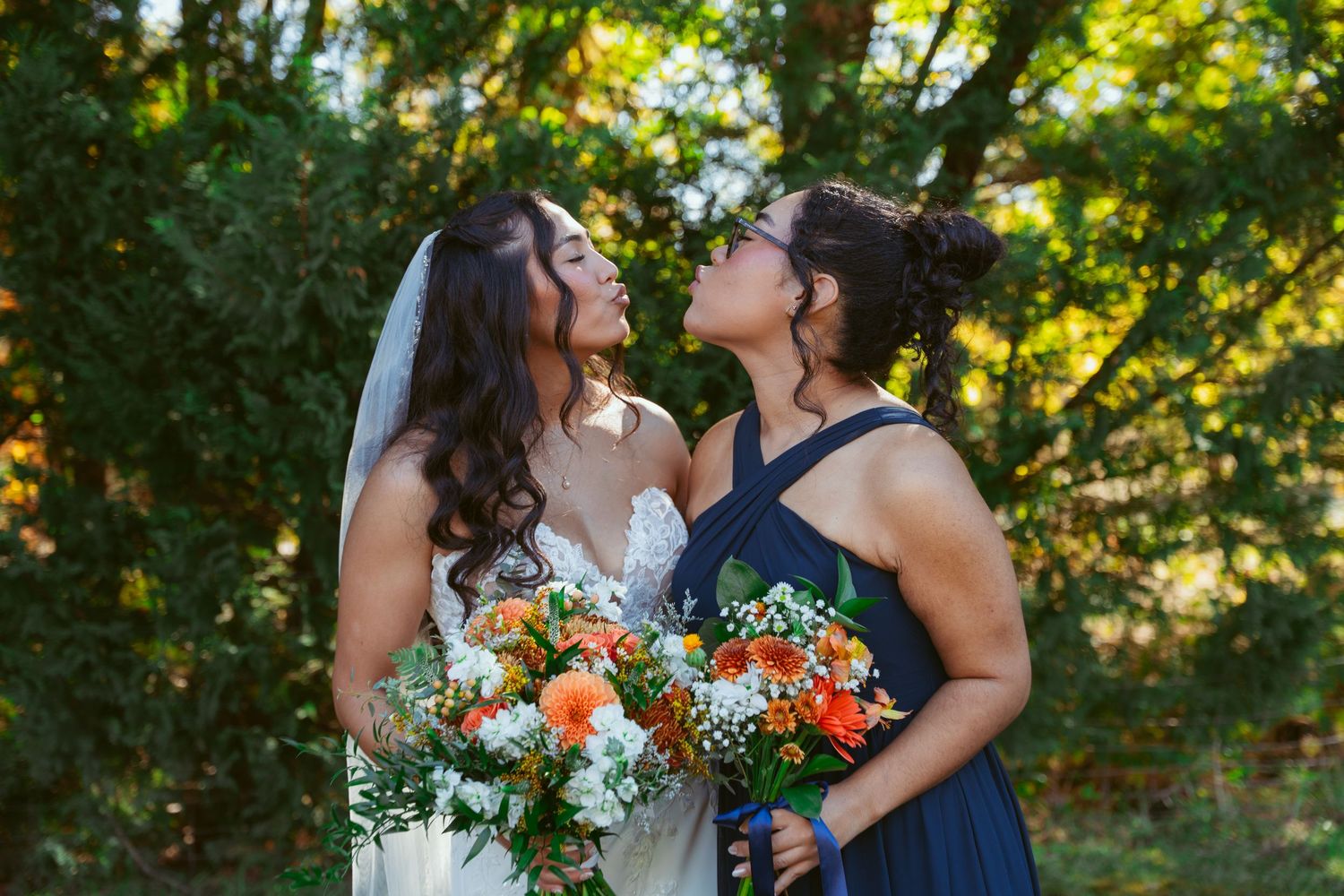Joyful wedding moment shared between two people with bright floral bouquets outdoors.
