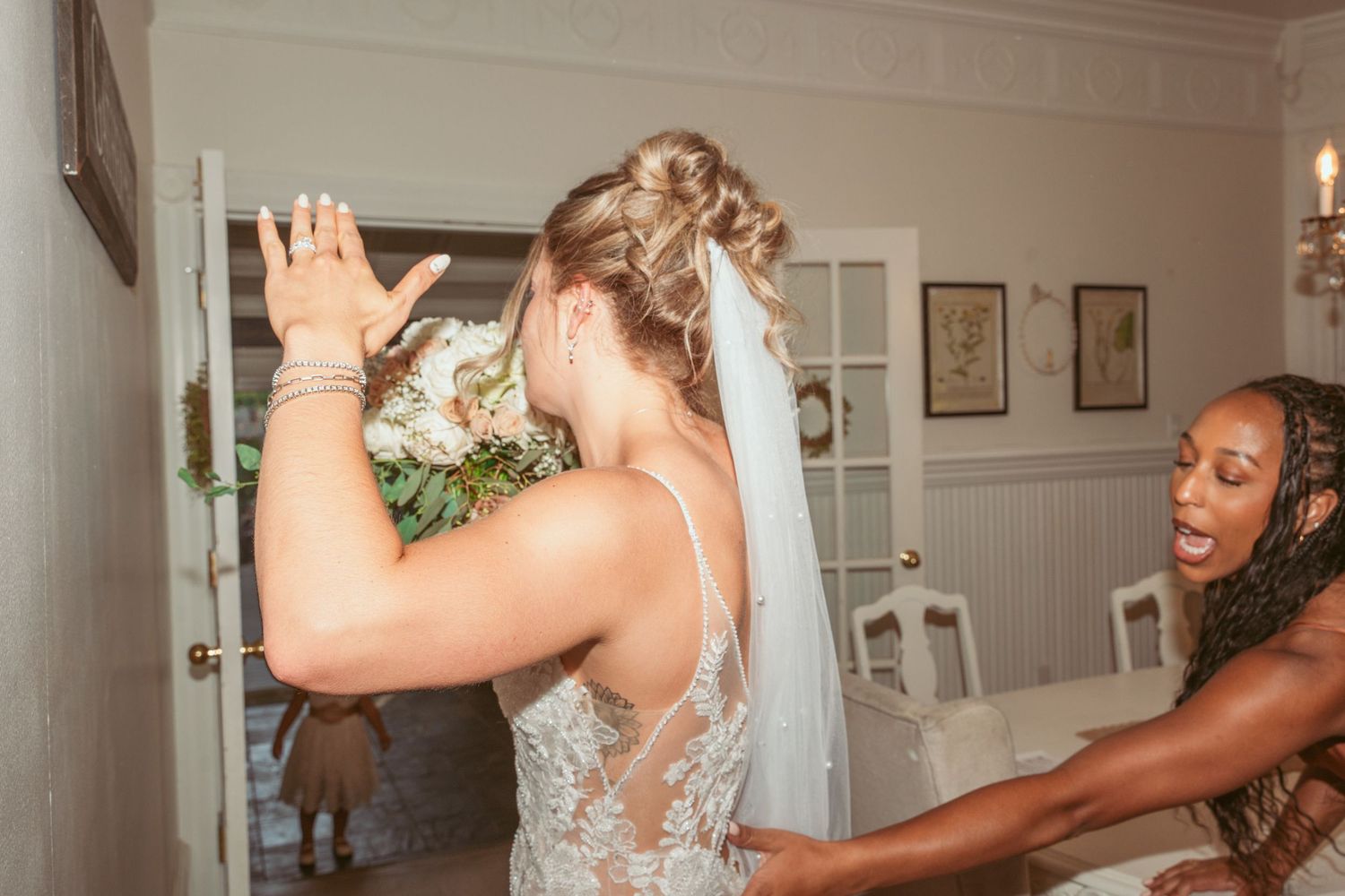 Wedding celebration in an elegant indoor venue with white walls and framed artwork.