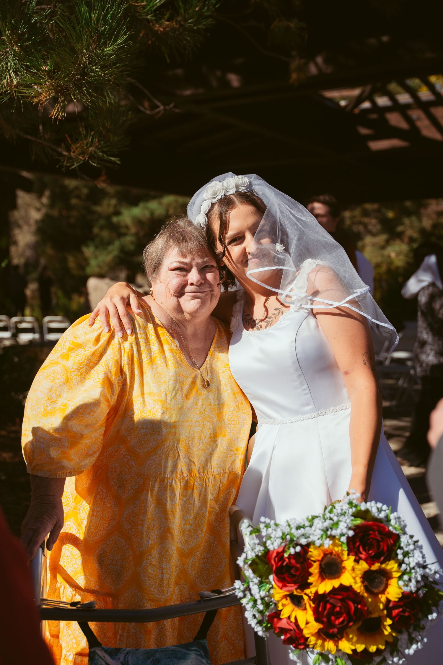 Candid wedding moments captured in sunlit outdoor setting with sunflower bouquet.