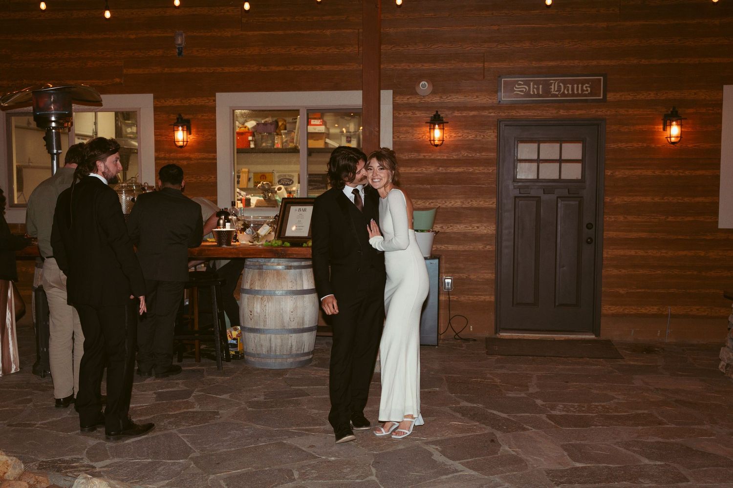 Indoor wedding venue with warm lighting and rustic wooden walls.