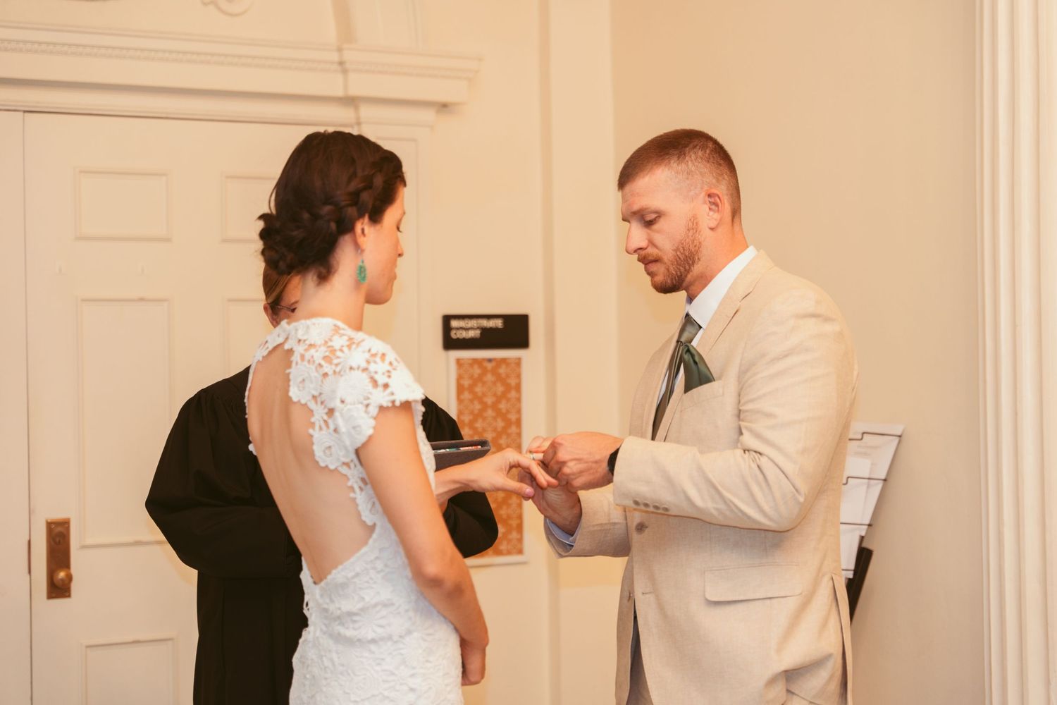 An intimate wedding ceremony moment captured in a classical architectural setting.