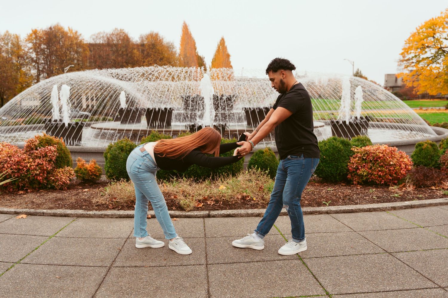 Sequence of dance moves performed on a walkway with autumn scenery in background.