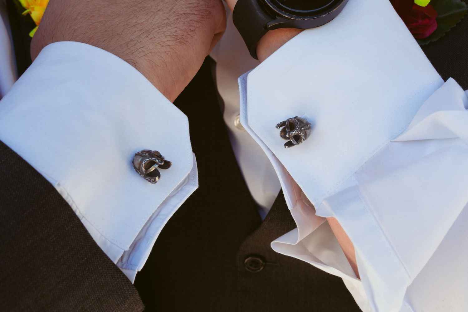 Close-up of white formal shirt cuffs with elegant cufflinks.