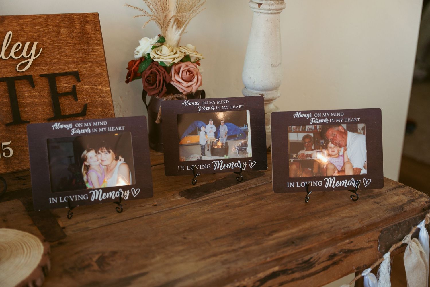 Wedding photo frames displayed on dark wooden table with sentimental messages.