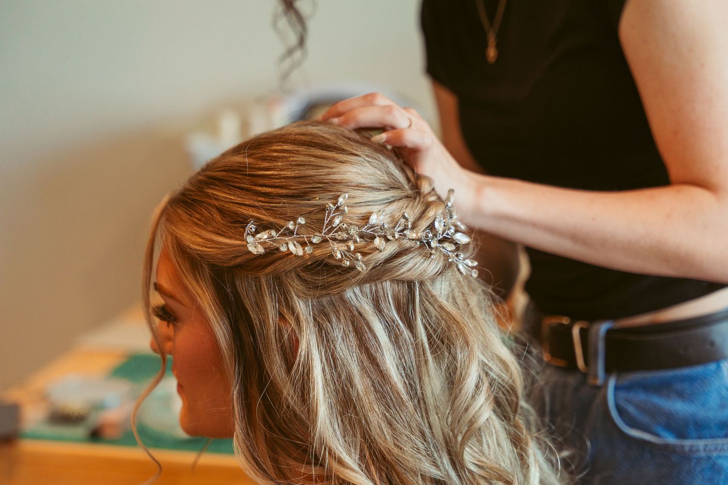 Hairstylist working on styling and arranging hair for a special occasion.