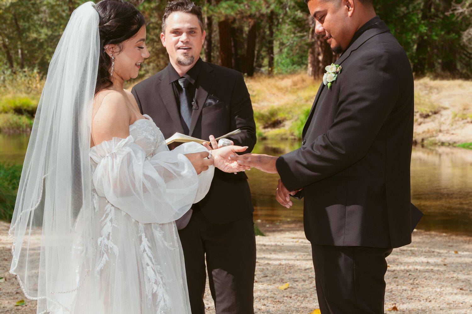 Intimate wedding ceremony moment captured against natural fall backdrop.