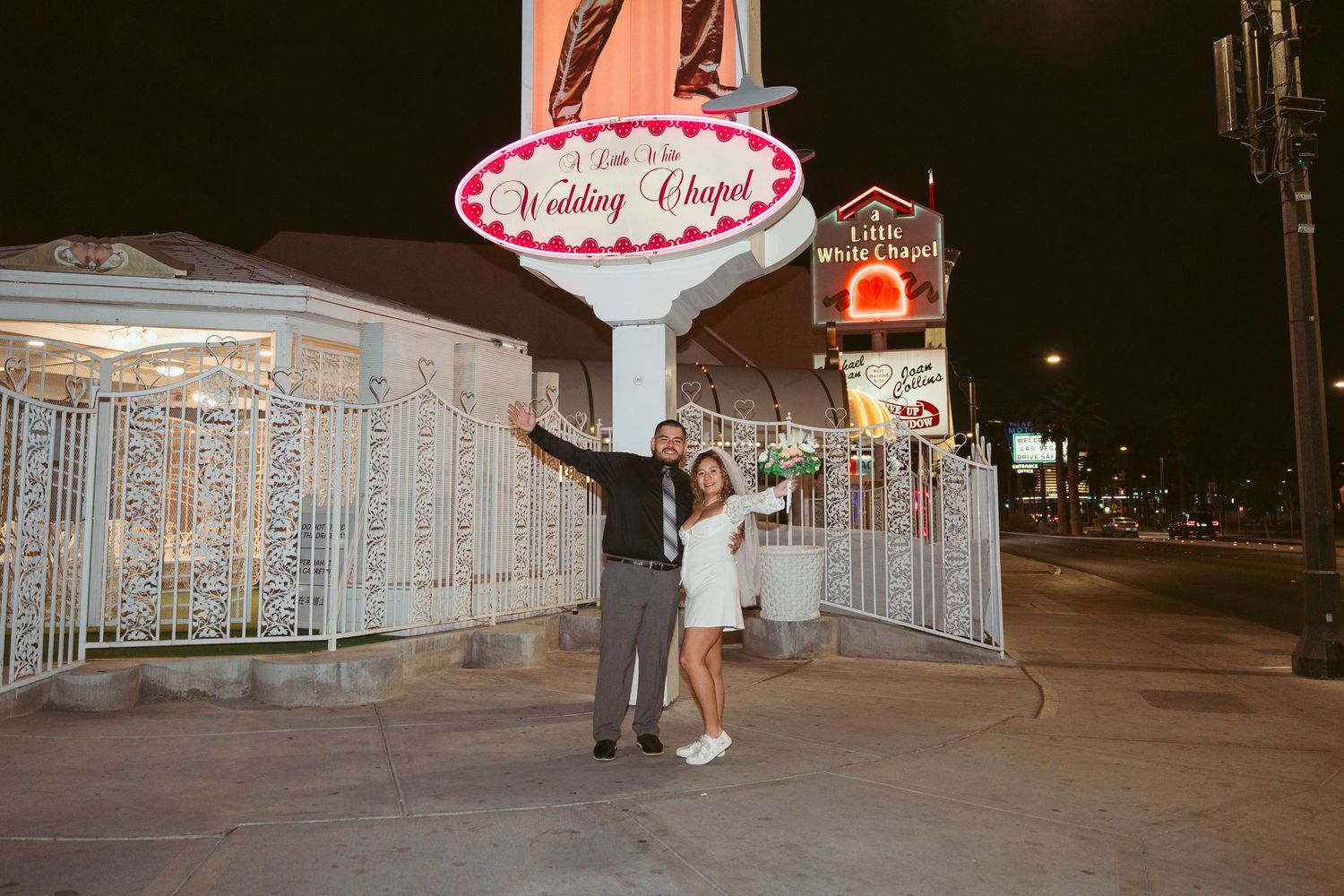 Nighttime wedding photos at an illuminated chapel entrance.