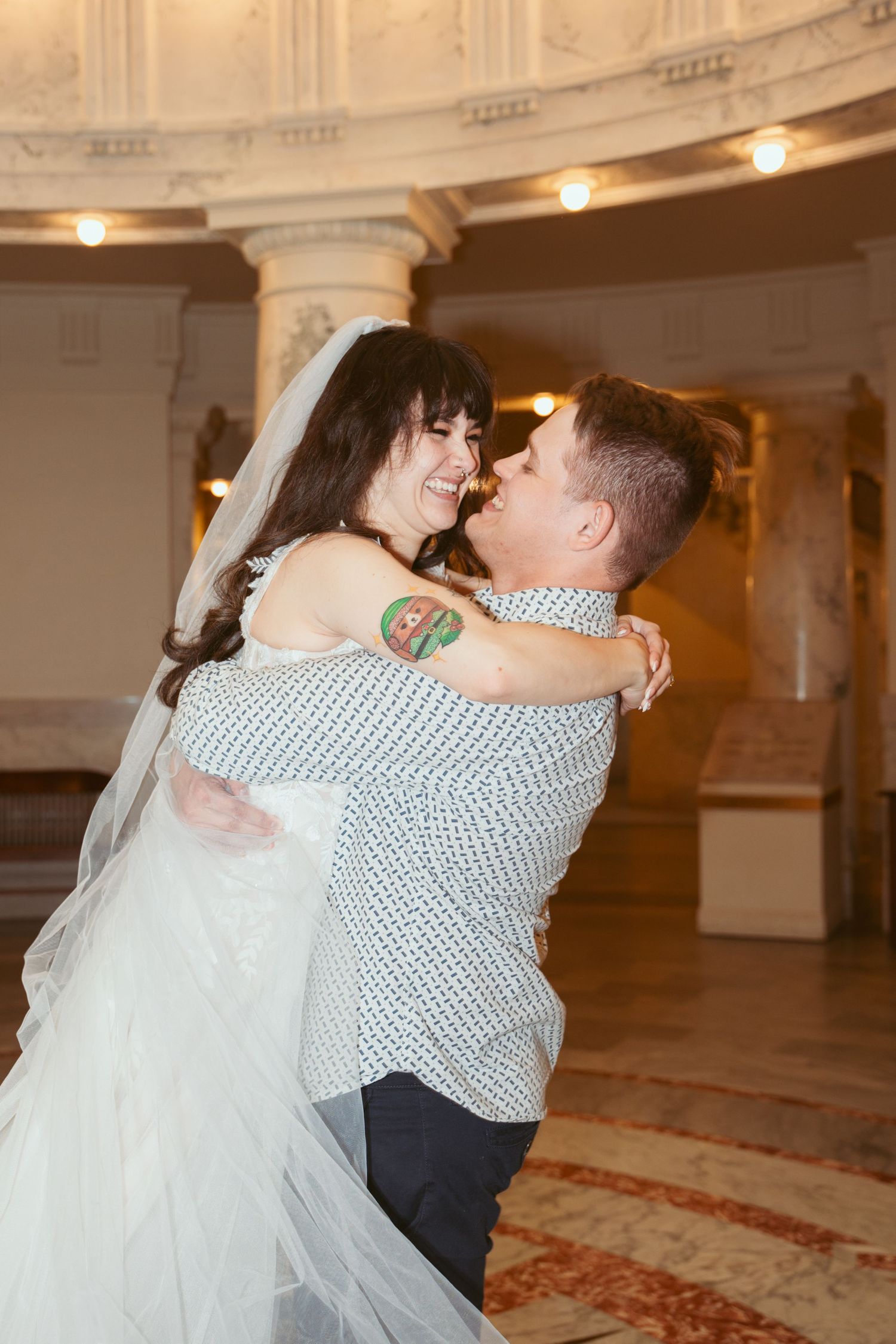 A romantic dance sequence captured in an elegant ballroom with classic architectural details.