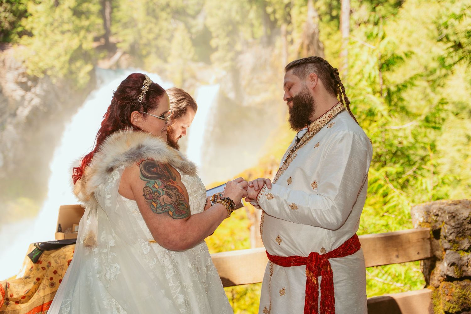Newlyweds share an intimate dance moment surrounded by trees and natural light.