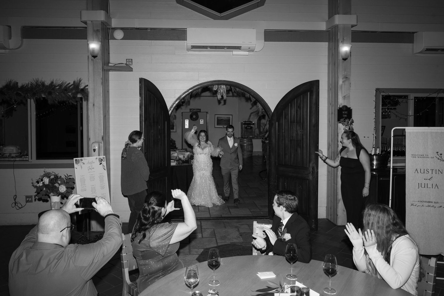 Dark reception hall with guests mingling and dancing in silhouette.