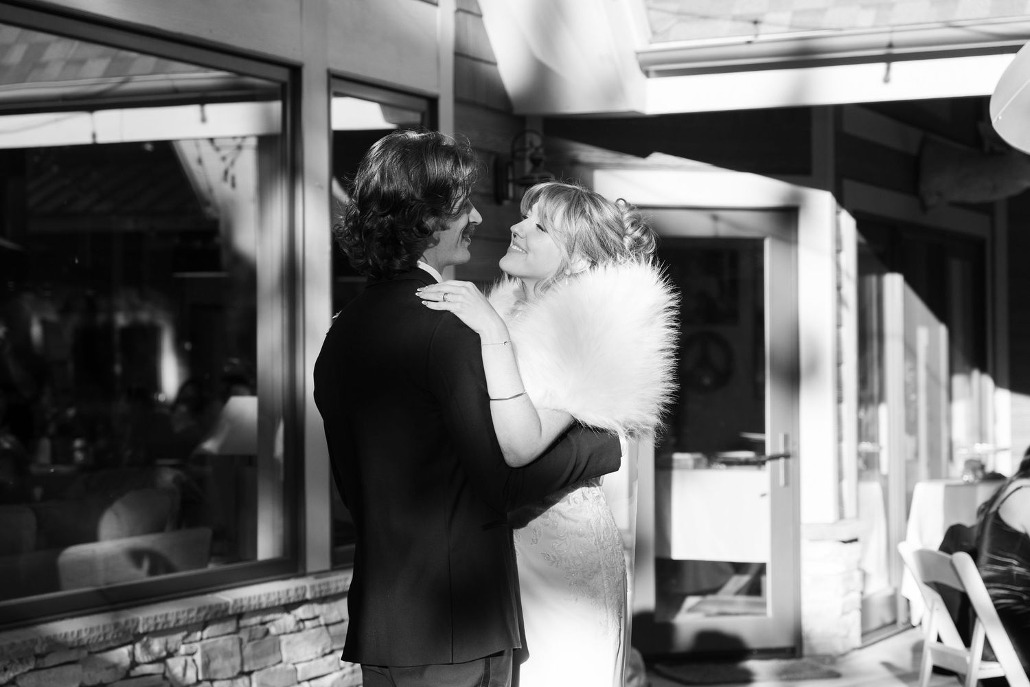 Black and white interior shots of a modern wedding venue with dramatic lighting.