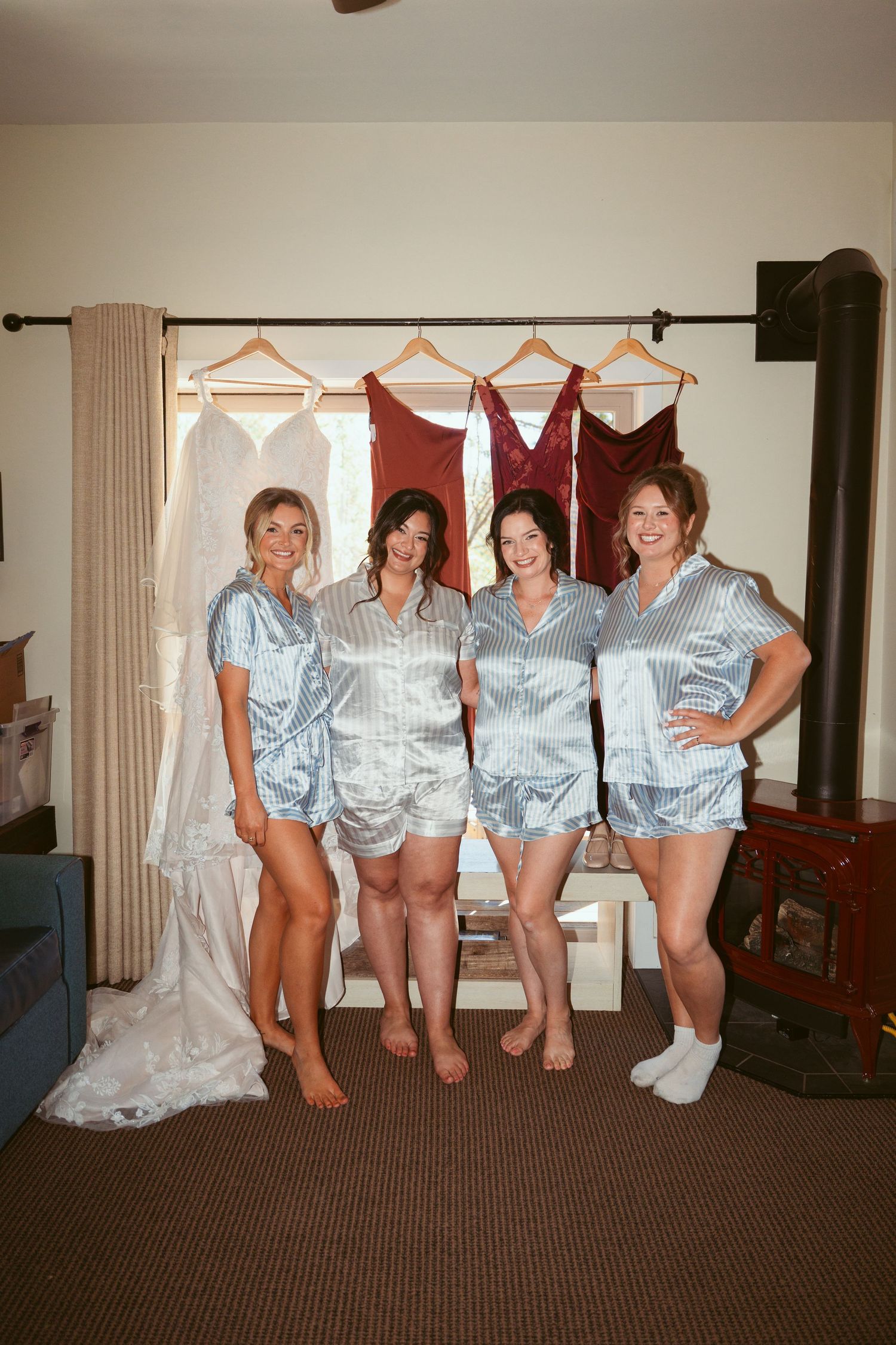 Group in matching striped robes sitting together showing off their matching outfits.