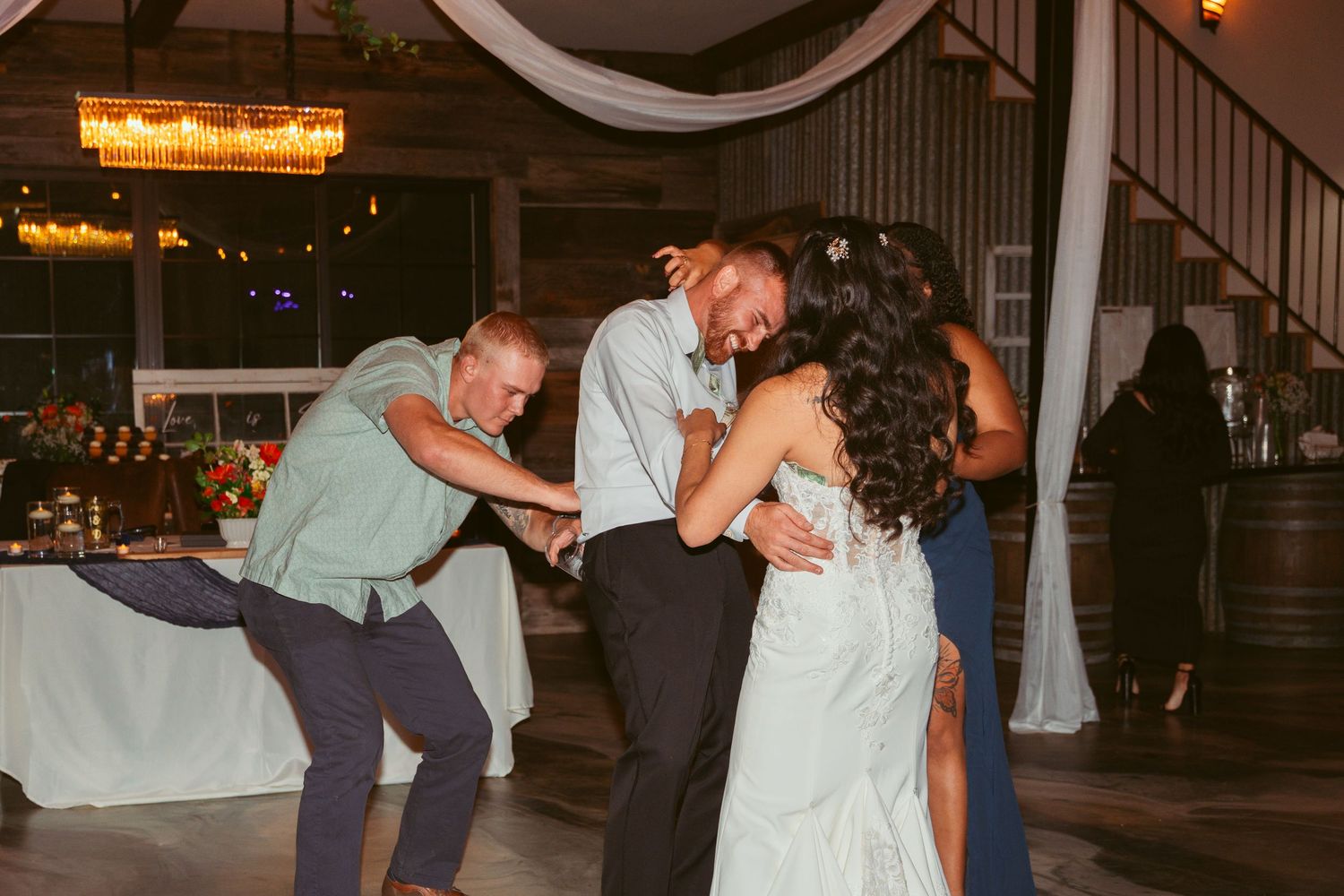 Wedding reception dance floor filled with guests enjoying lively celebration.