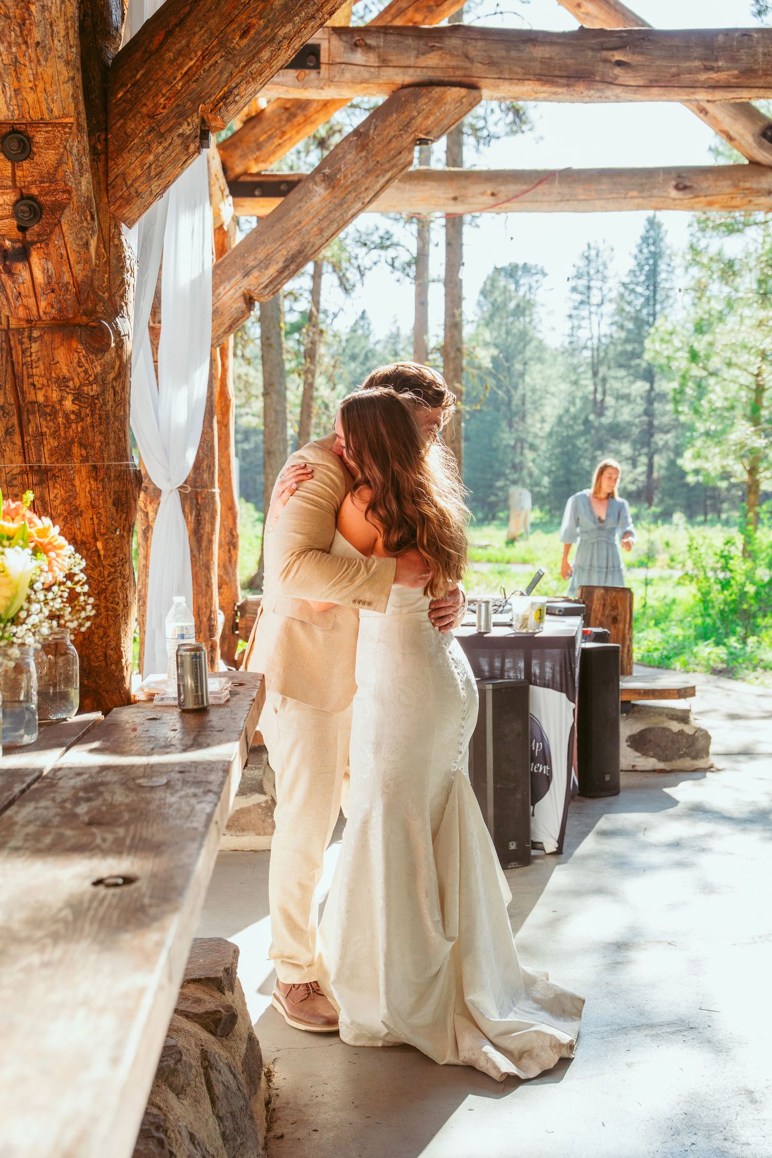 Wedding dance in a sunlit rustic pavilion with white flowing dress.