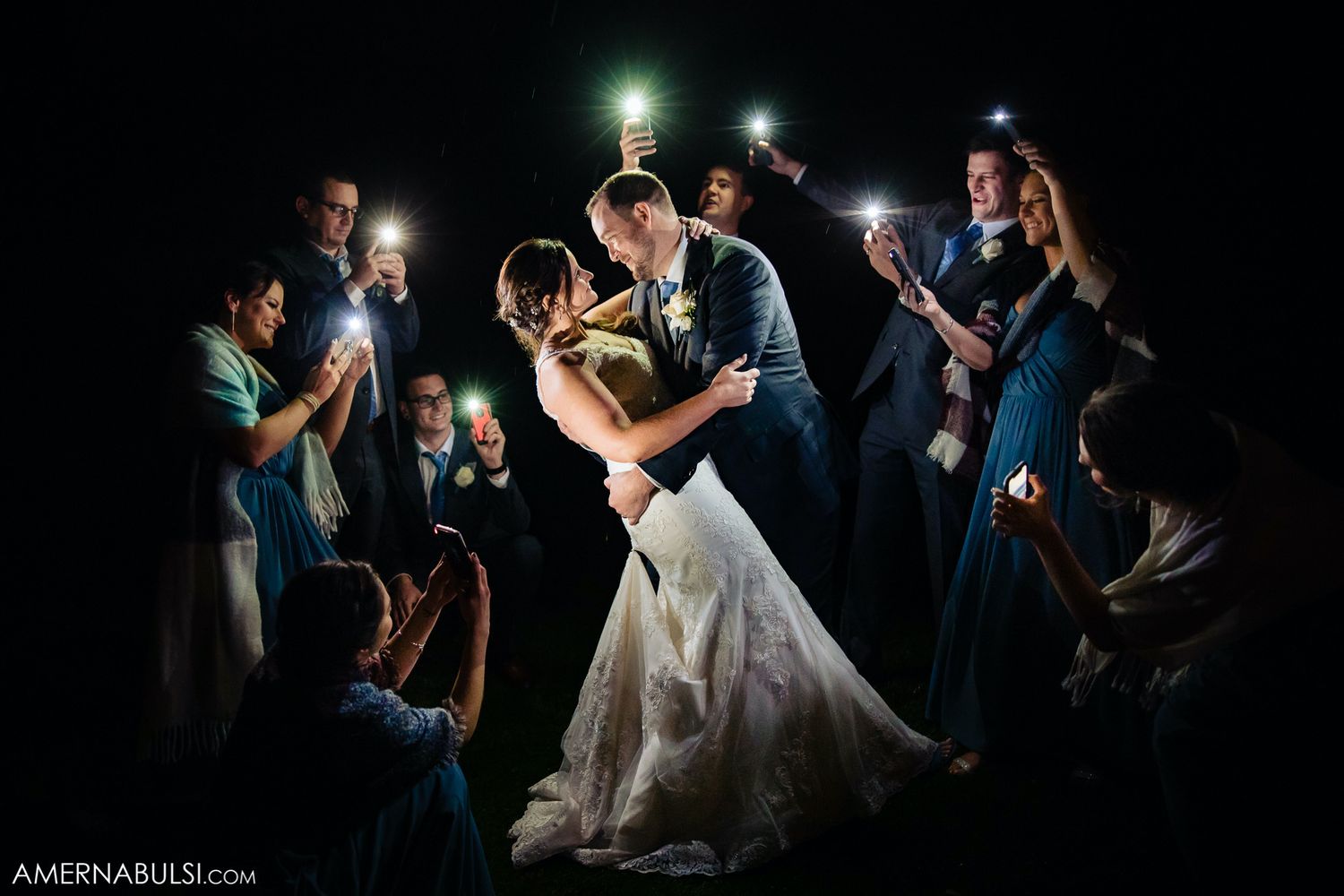 Wedding reception dance floor moments captured in dramatic nighttime lighting.