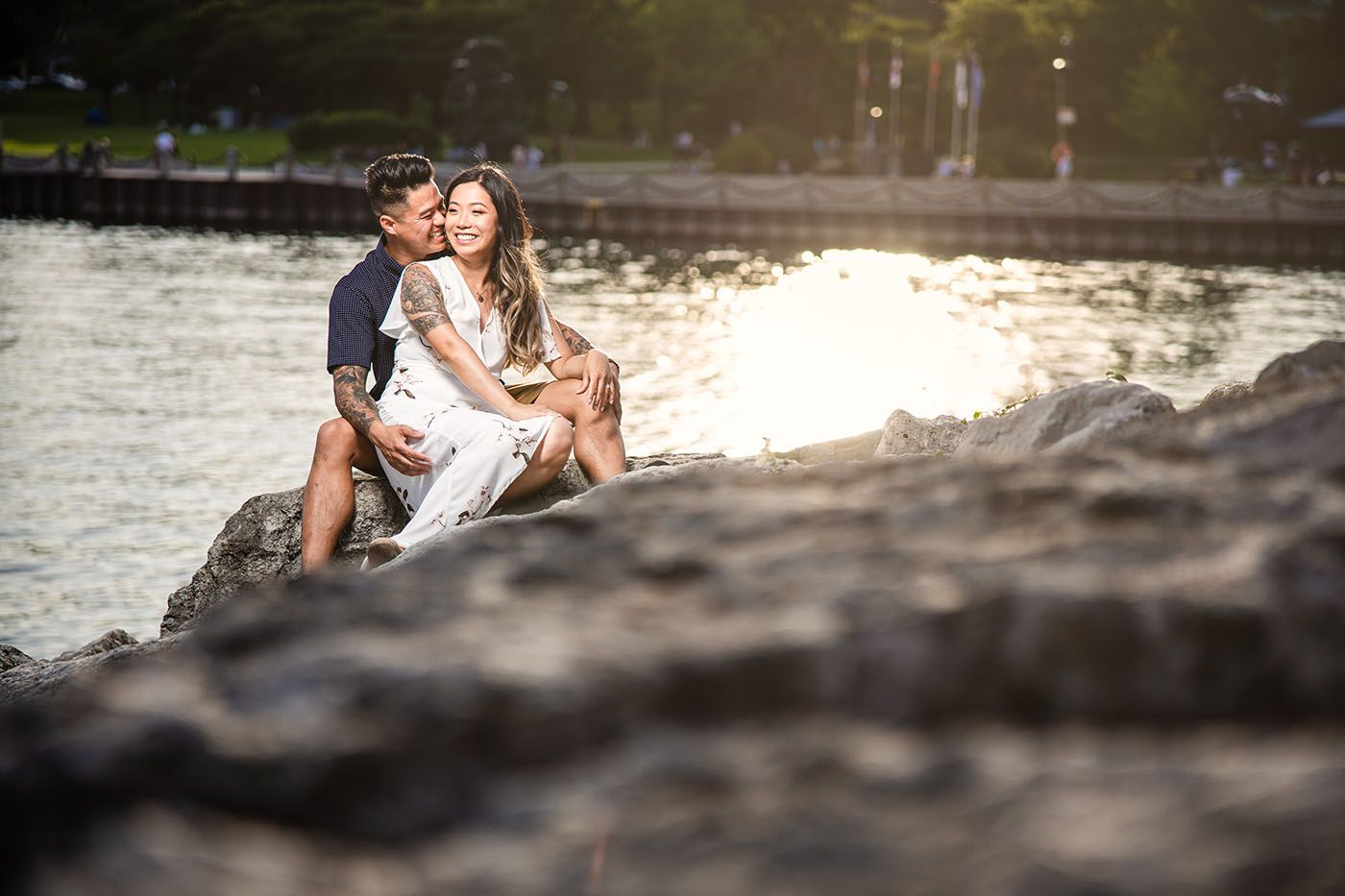 A romantic photo session on rocky terrain with natural lighting.