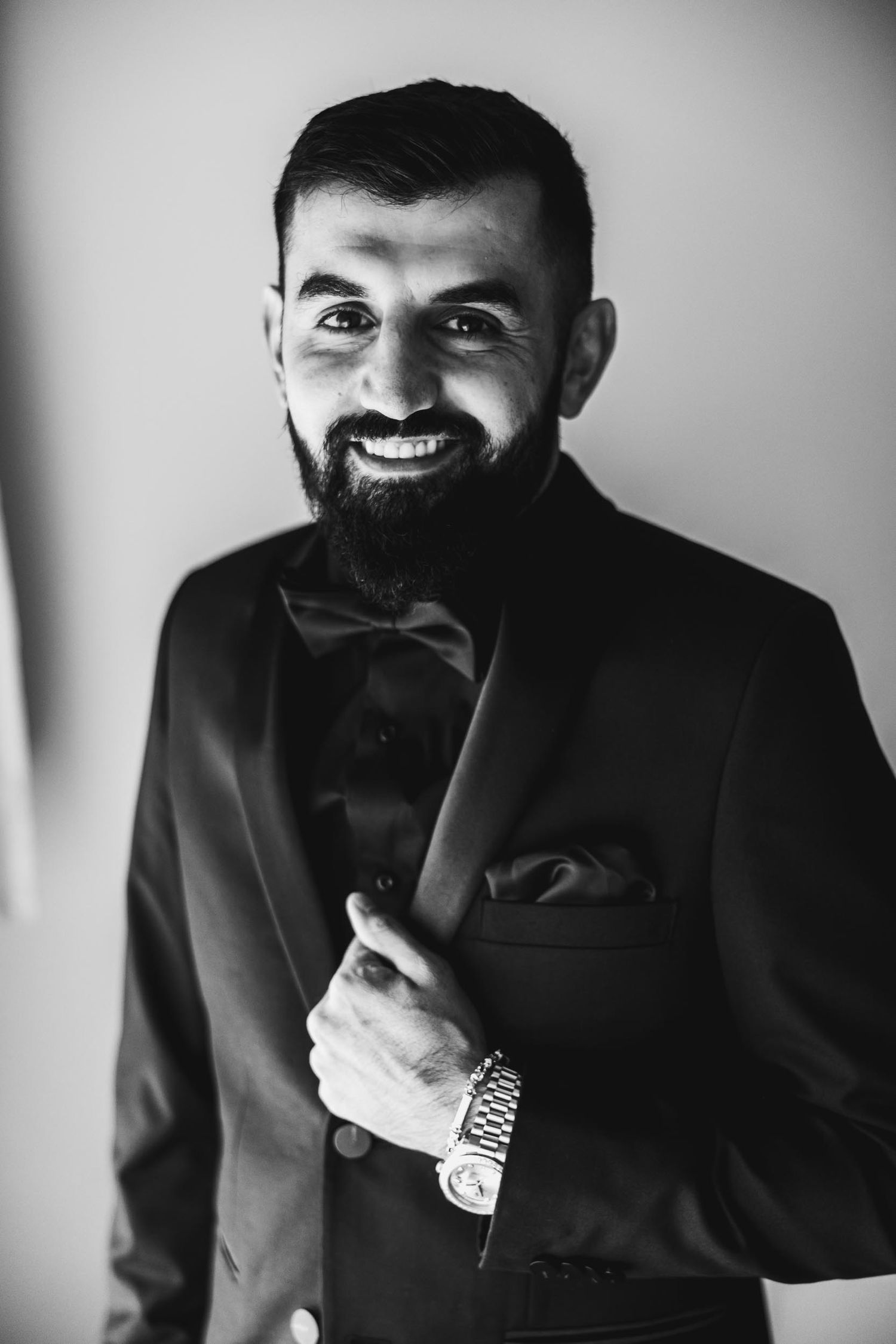 Black and white portrait of a formally dressed man in a bowtie and suit.