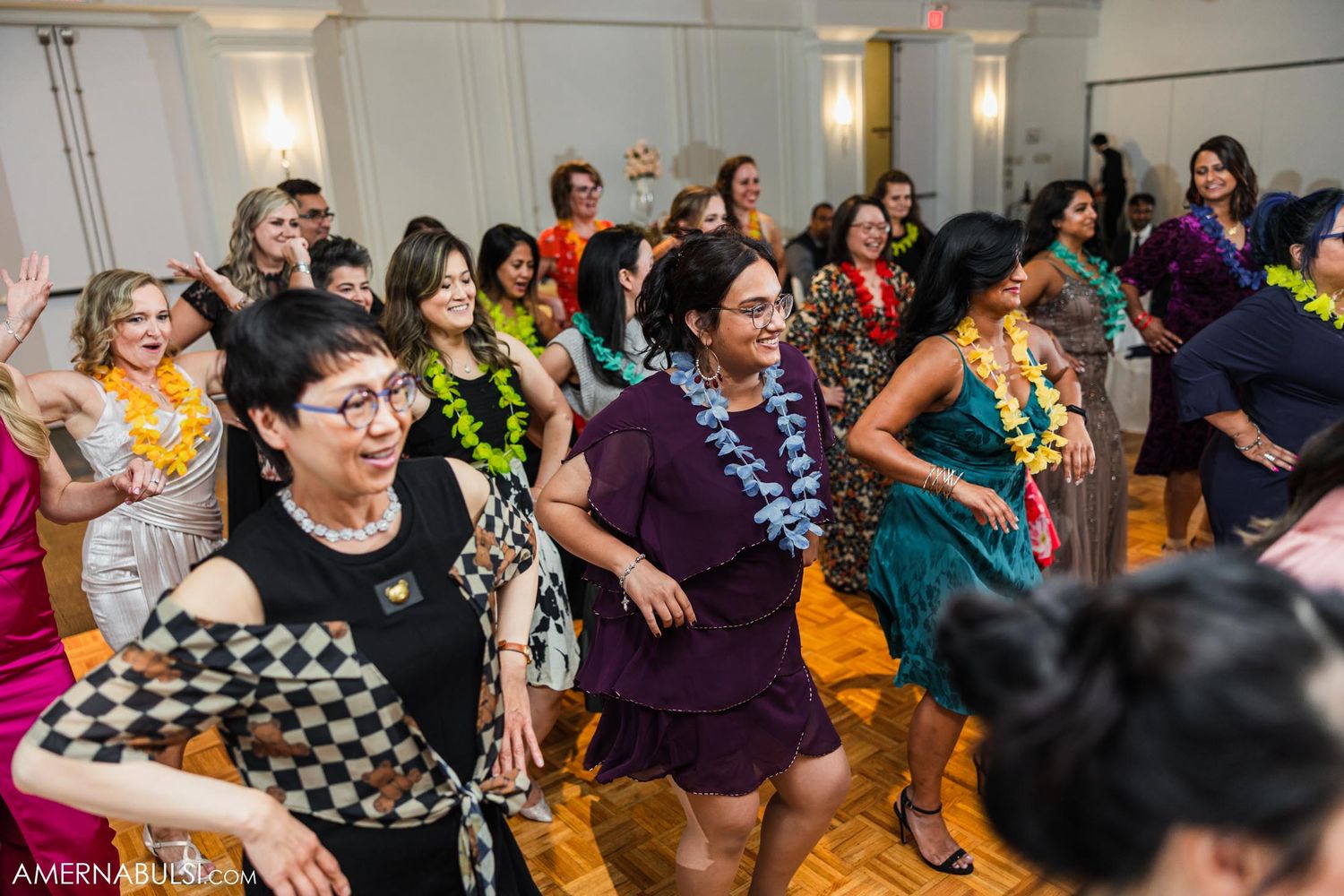 Wedding guests dancing and having fun on the dance floor.
