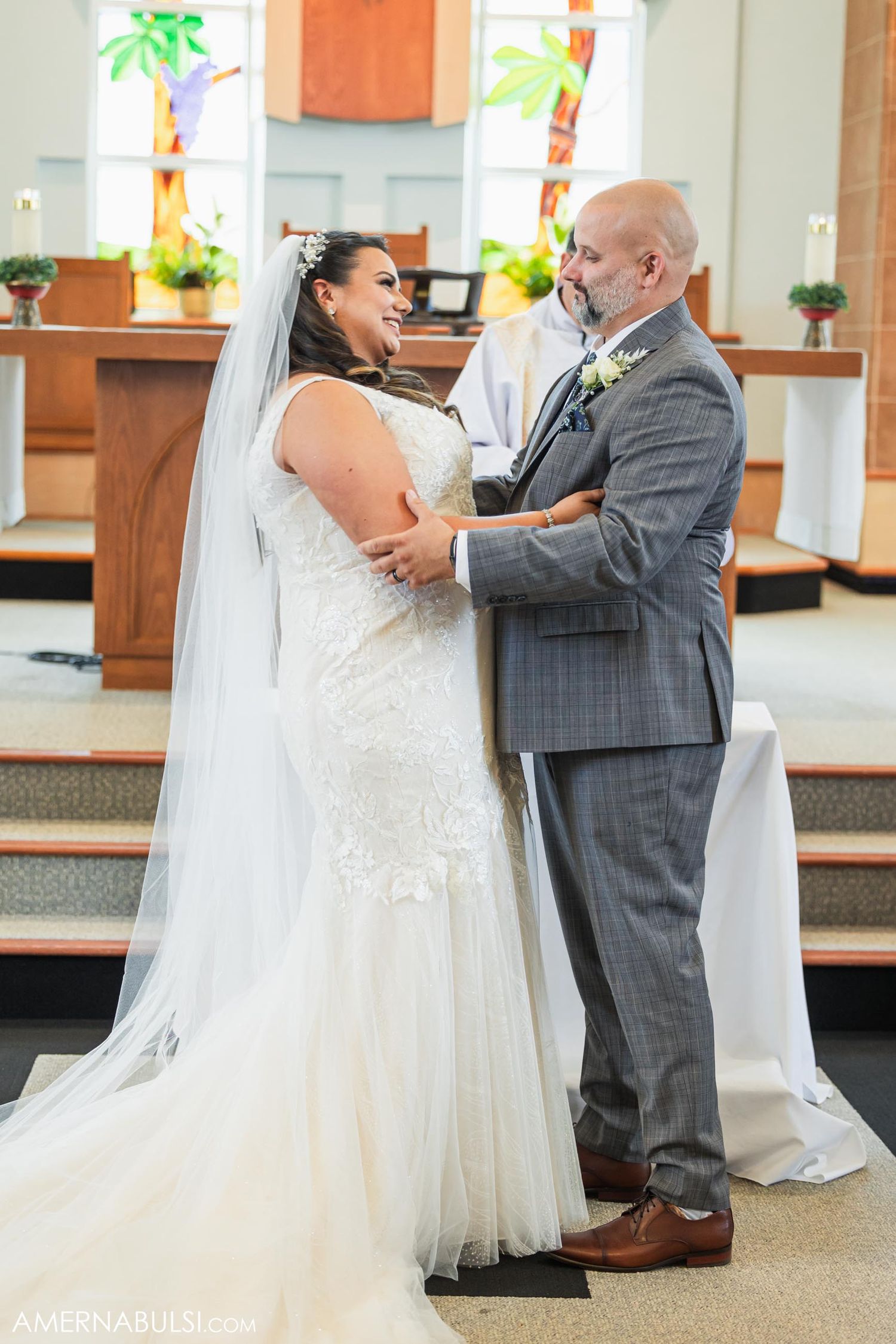 Wedding couple shares intimate moment during church ceremony.