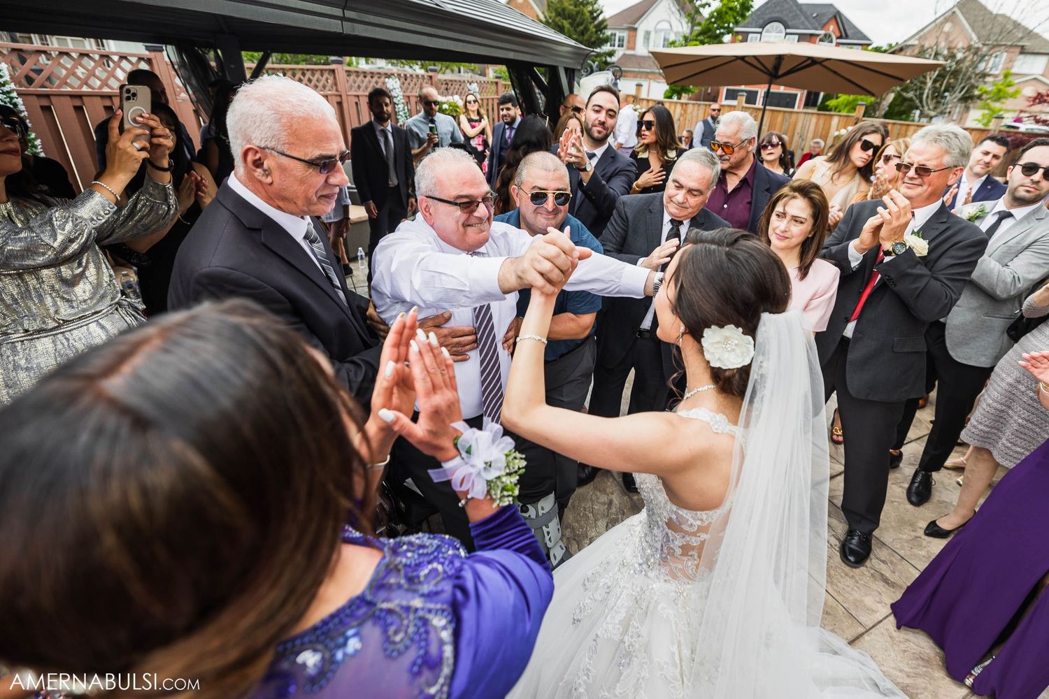 Wedding guests gathered in celebration at an outdoor reception venue with plenty of dancing.