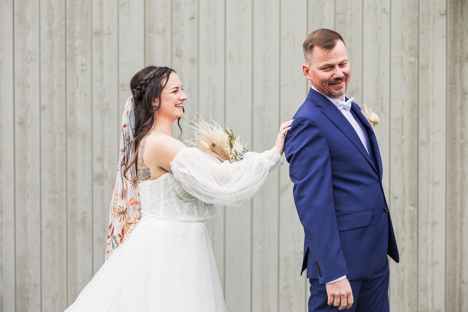 Playful wedding portrait moment between couple outdoors.