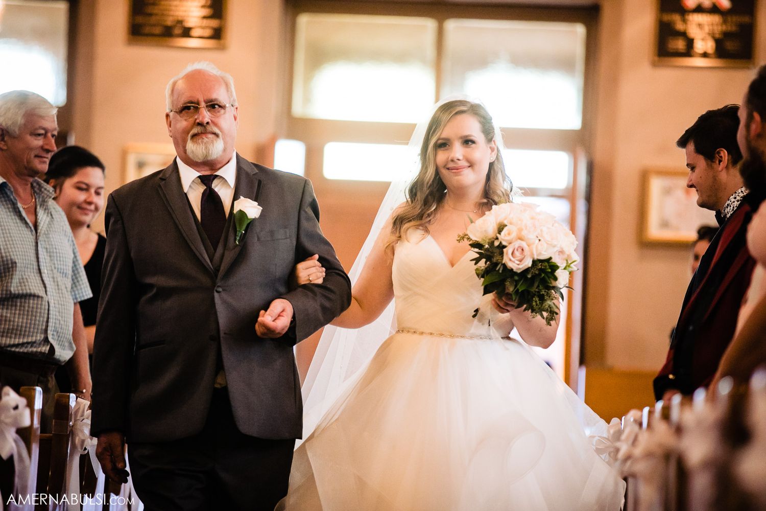 Wedding ceremony sequence captured in a traditional church with peach-colored walls.