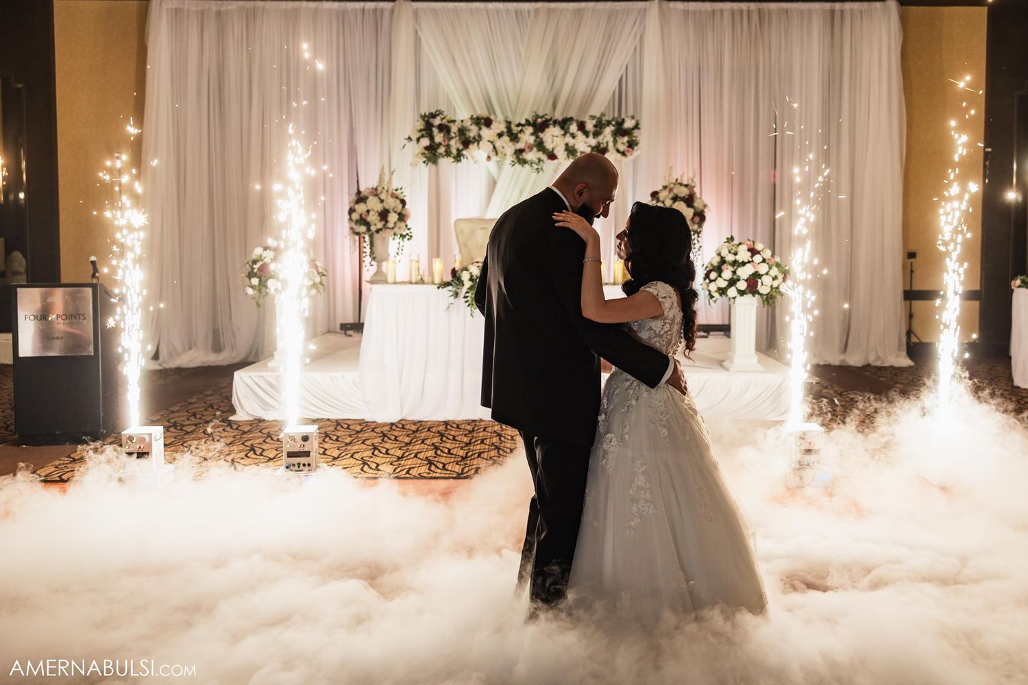 A romantic wedding dance with fog and sparkling lights creating a dreamy atmosphere.