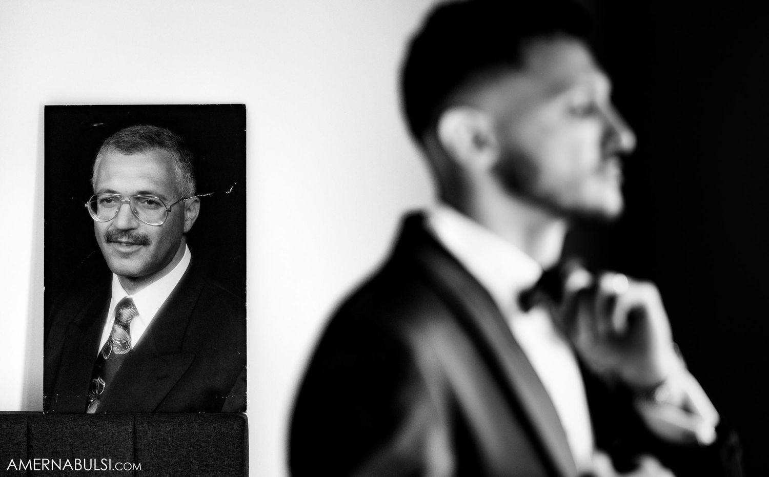Artistic composition with formal portrait in background and silhouette in foreground.