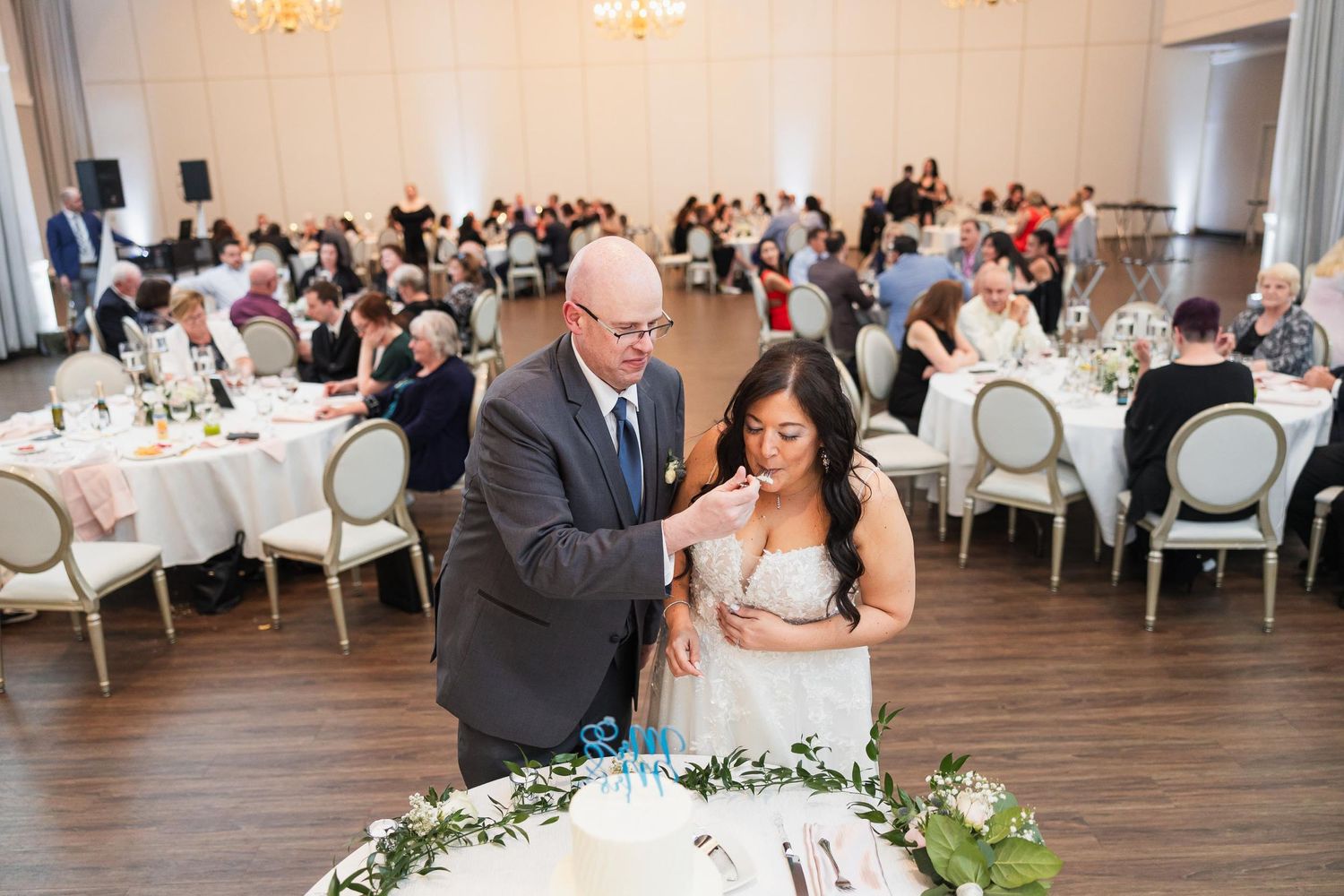 A couple sharing a special moment at their wedding reception head table.