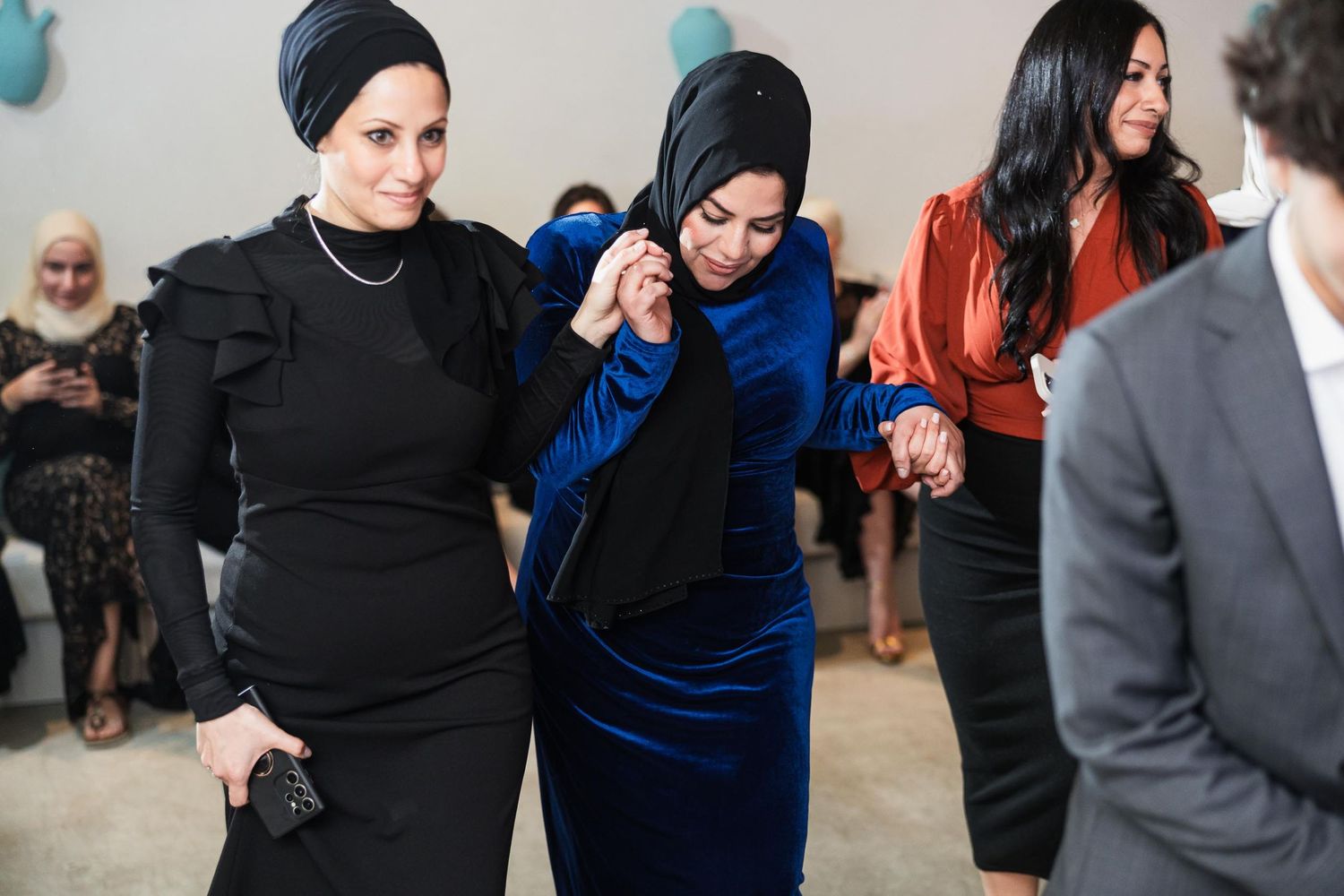 Guests in formal attire share a joyful moment during an elegant celebration.