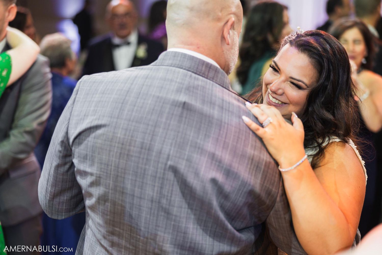 Tender moment between couple dancing at their wedding reception.