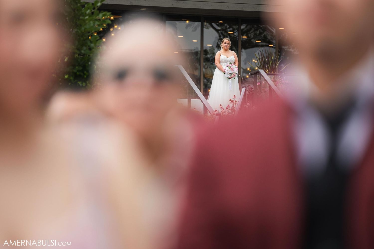 Artistic soft focus photograph of wedding ceremony with blurred foreground elements.