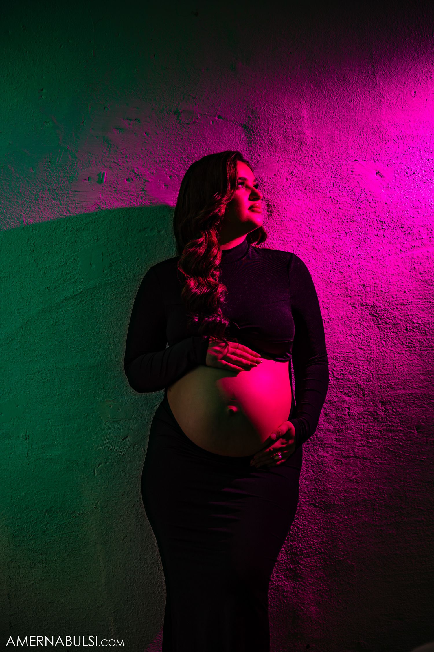 A creative maternity photo at the Millwork Creative Studio using lights and gels