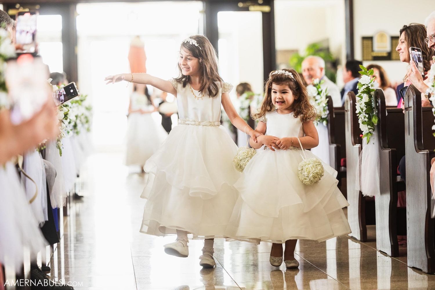 A candid black and white wedding photo showing facial expressions through architectural framing.